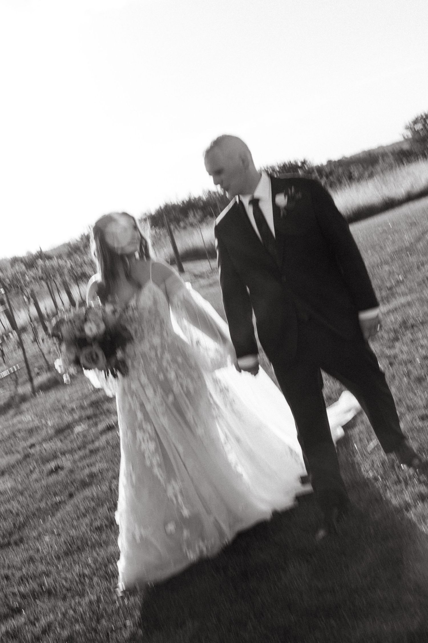 Black and white series of wedding photos captured in a natural outdoor setting.