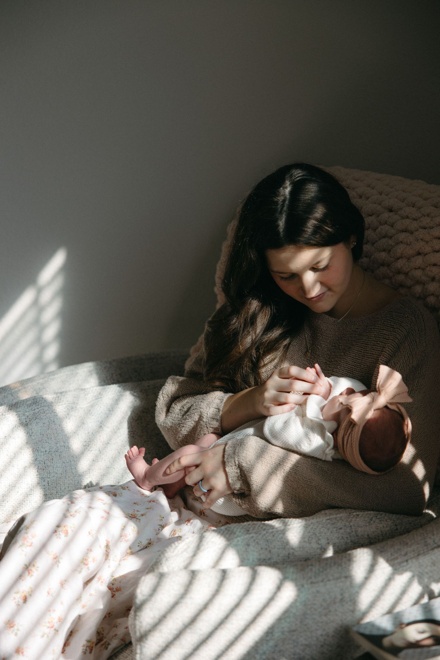 Sunlight streaming through window creates patterns on cozy bed scene.