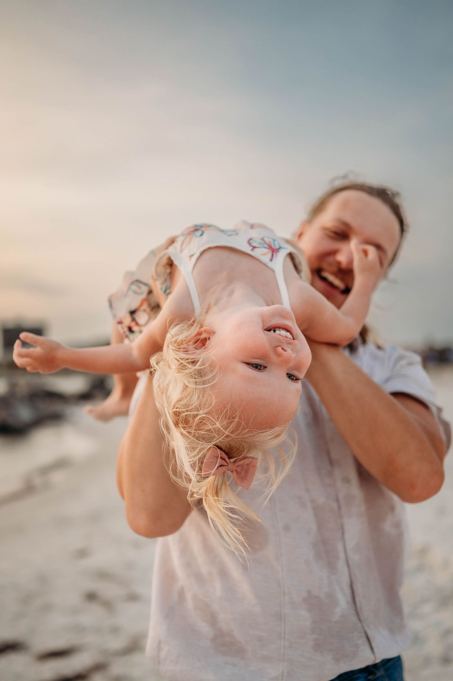 Pure joy captured during playful moments on a sunny beach day.