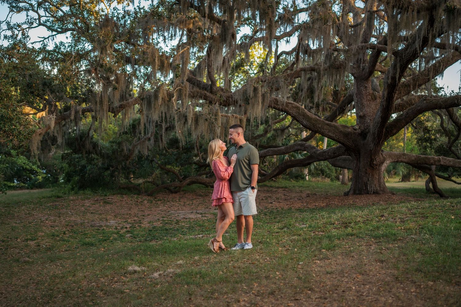 Natural outdoor photography session under massive oak trees with trailing moss.