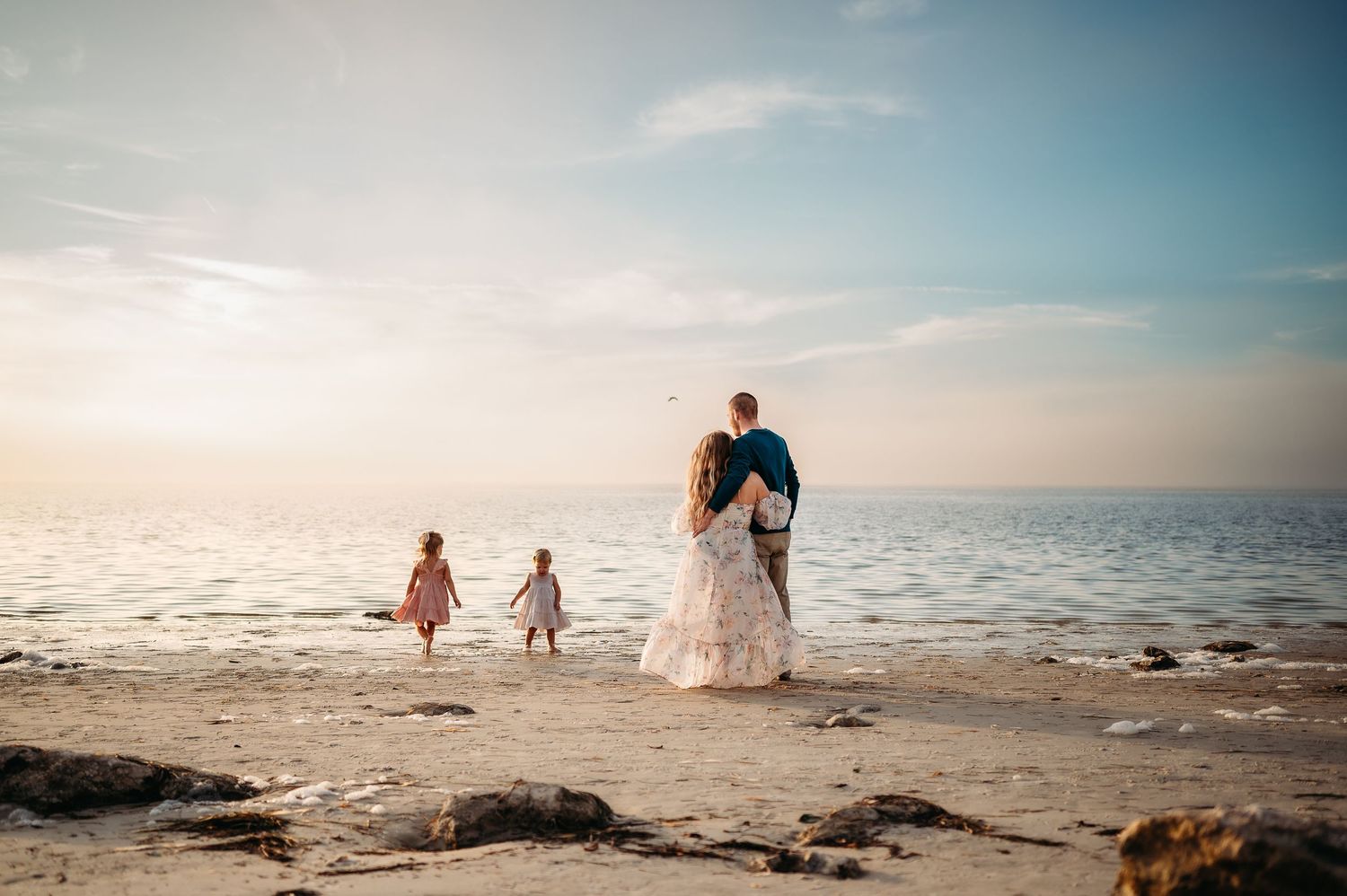 Scenic beach landscape with gentle waves and golden sunset light.