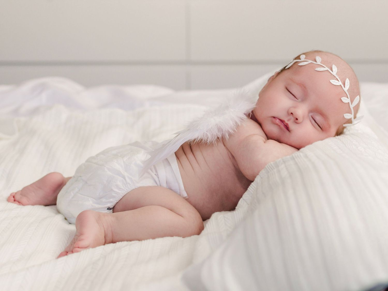 Newborn baby sleeping on cream blanket, lifestyle newborn photography in Essex