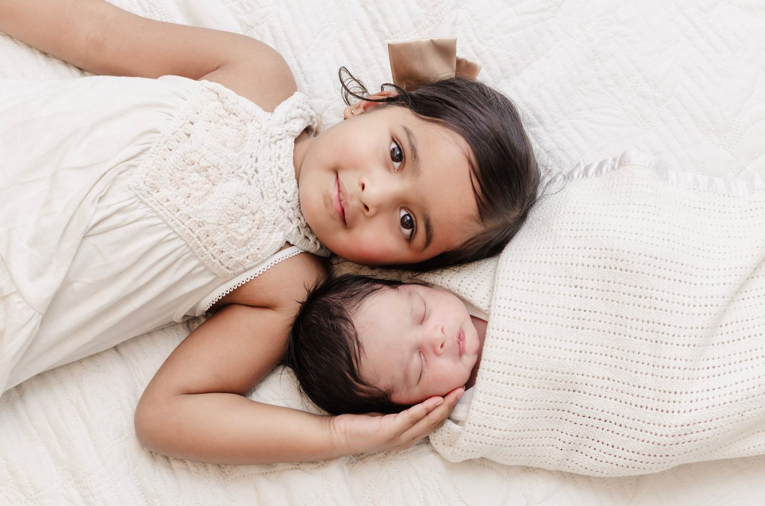 Mother cuddling her newborn baby, lifestyle family photography in Essex