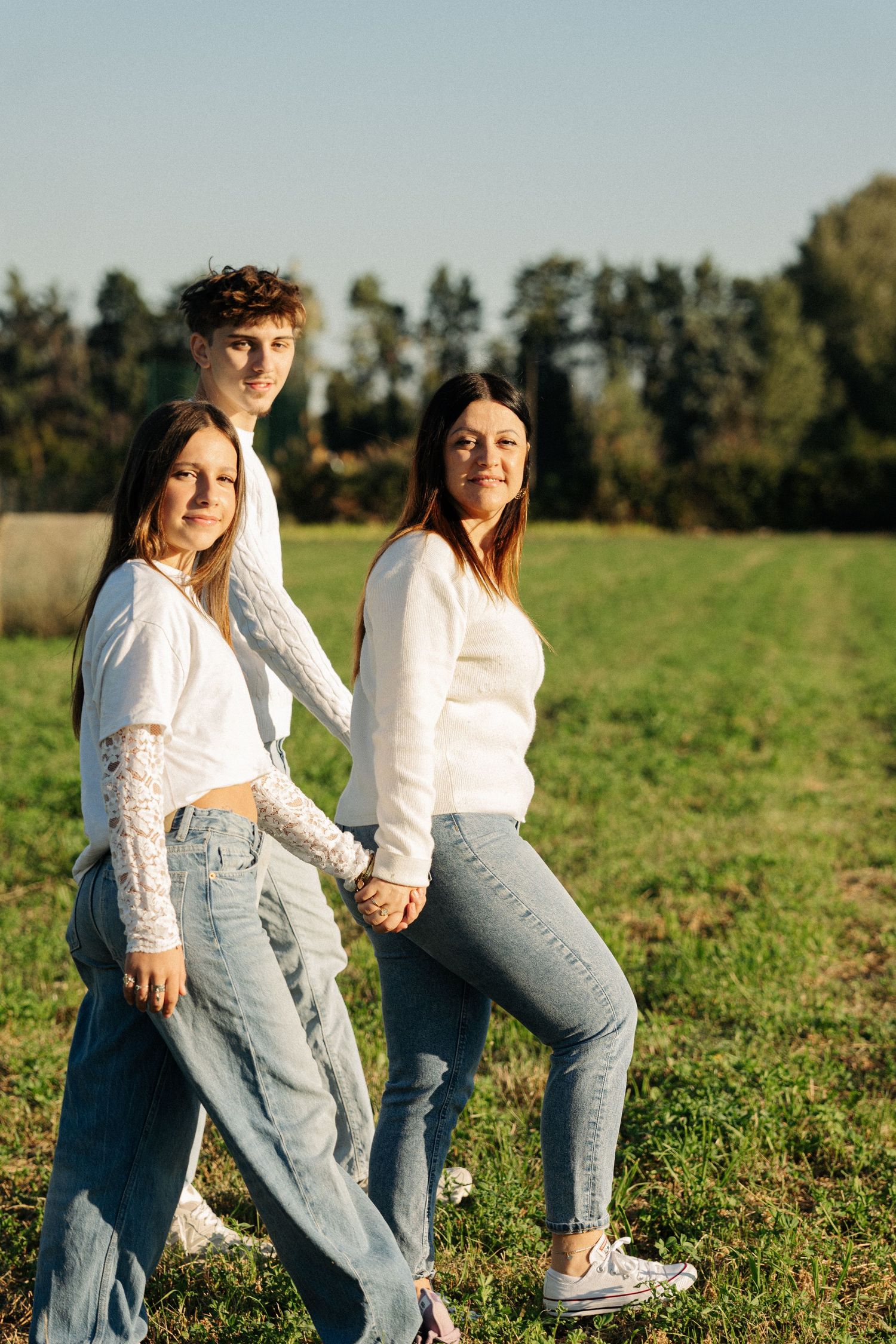 Maman et ses deux adolescents lors d'une séance photo en famille au lever du soleil.