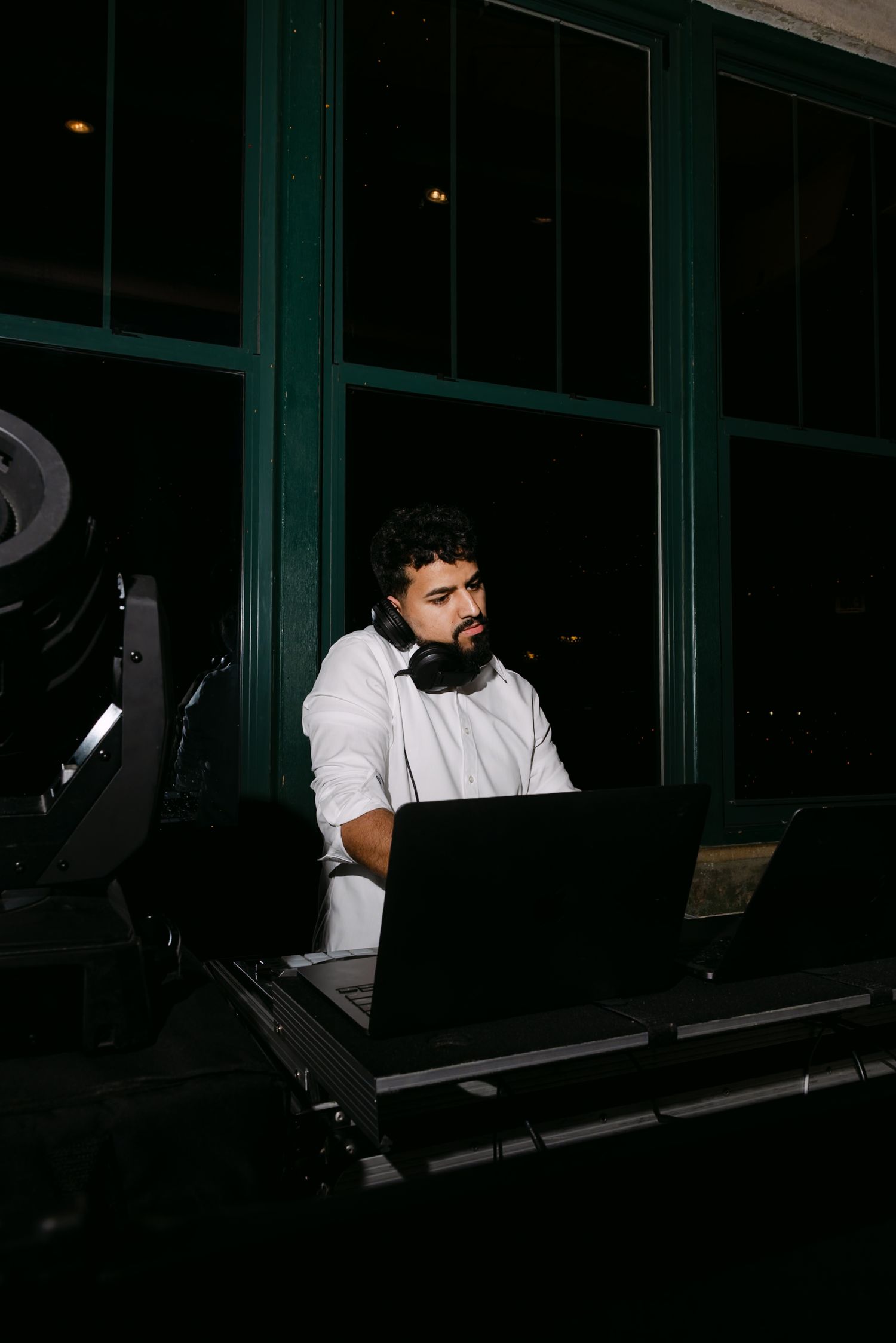 DJ behind the booth, flash heavy editorial look