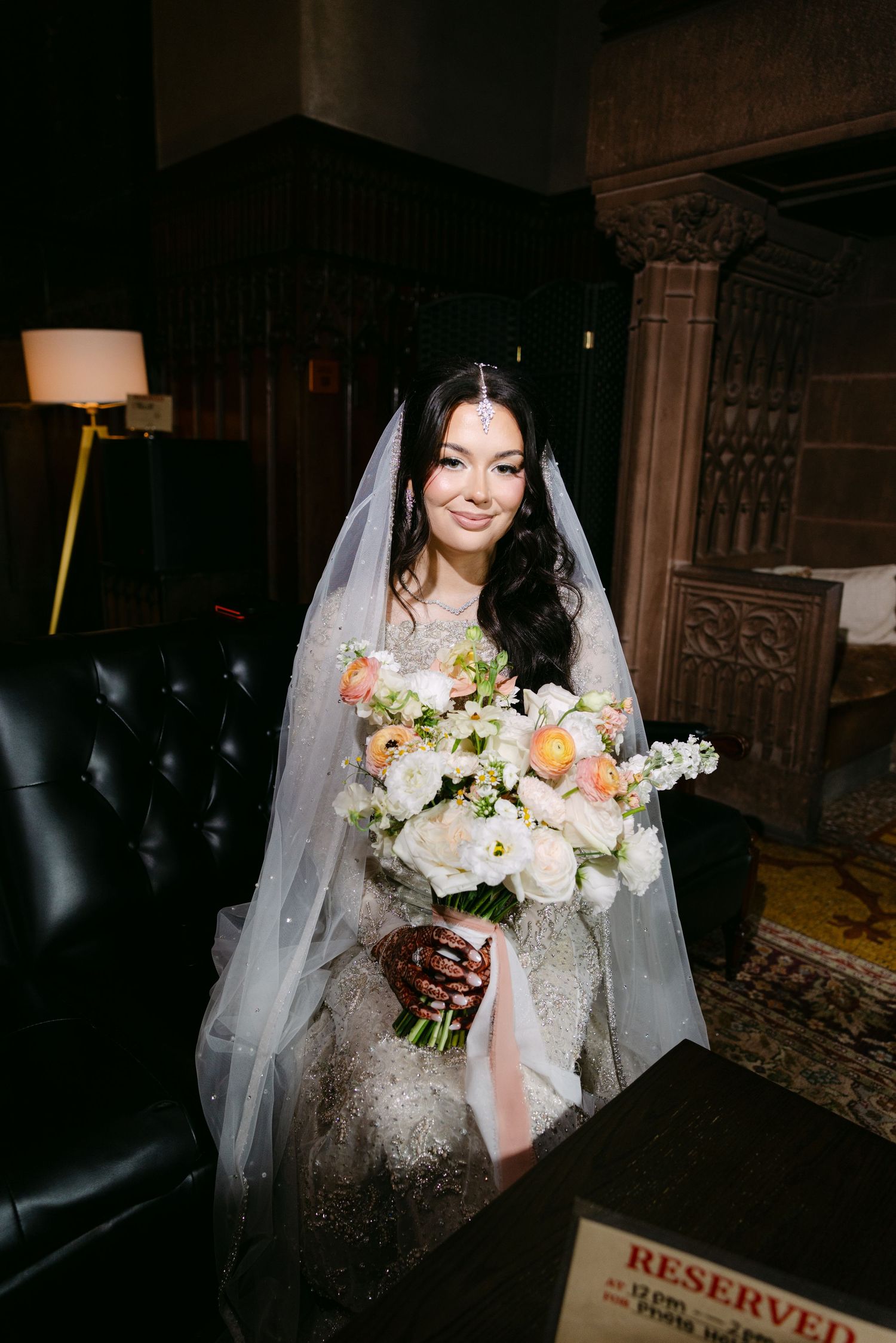Editorial magazine style image of female bride in bridal outfit holding flowers. Harsh-flash. High-flash.