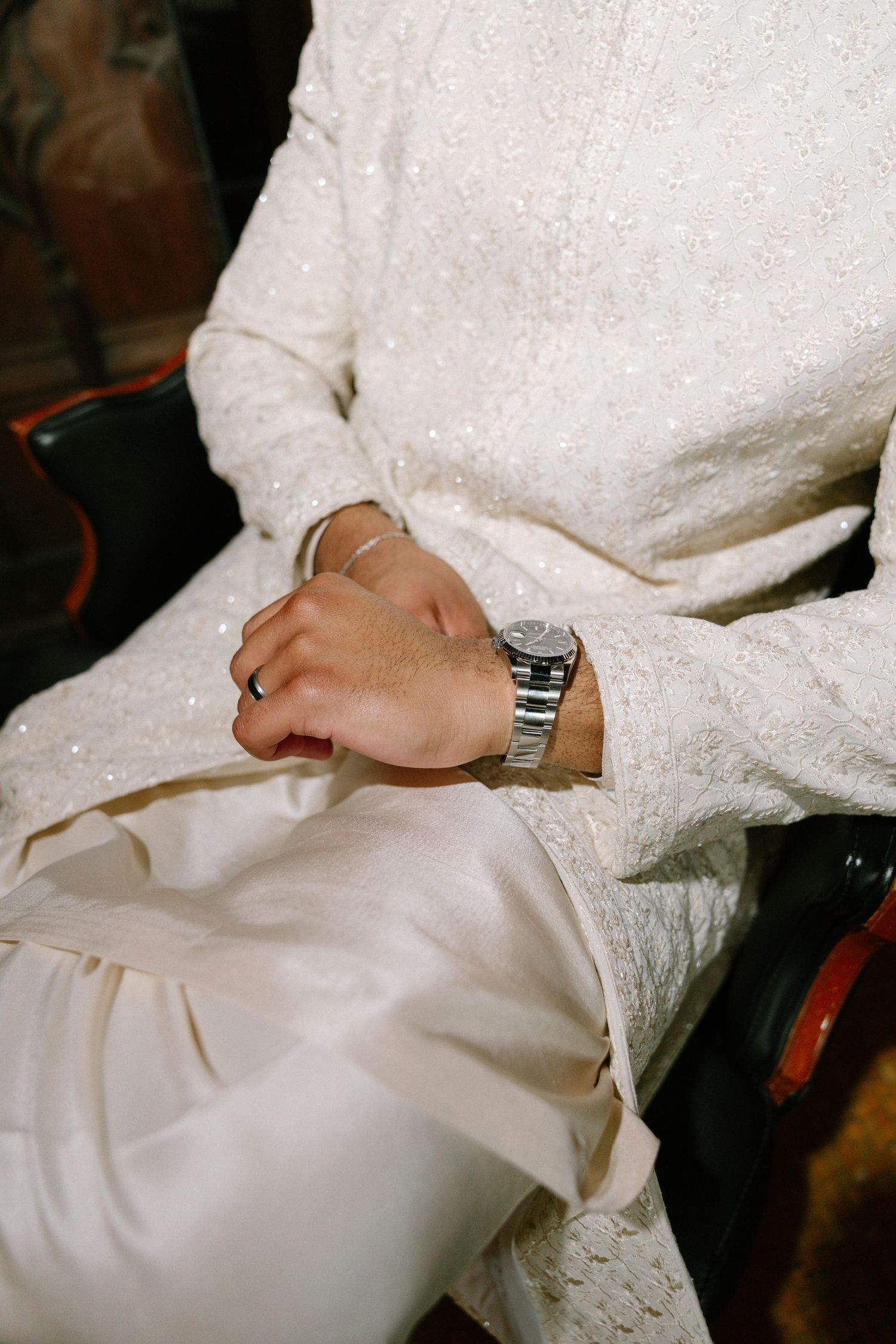 Editorial magazine style image of male groom in desi/south asian wedding khurta wearing watch, high-flash