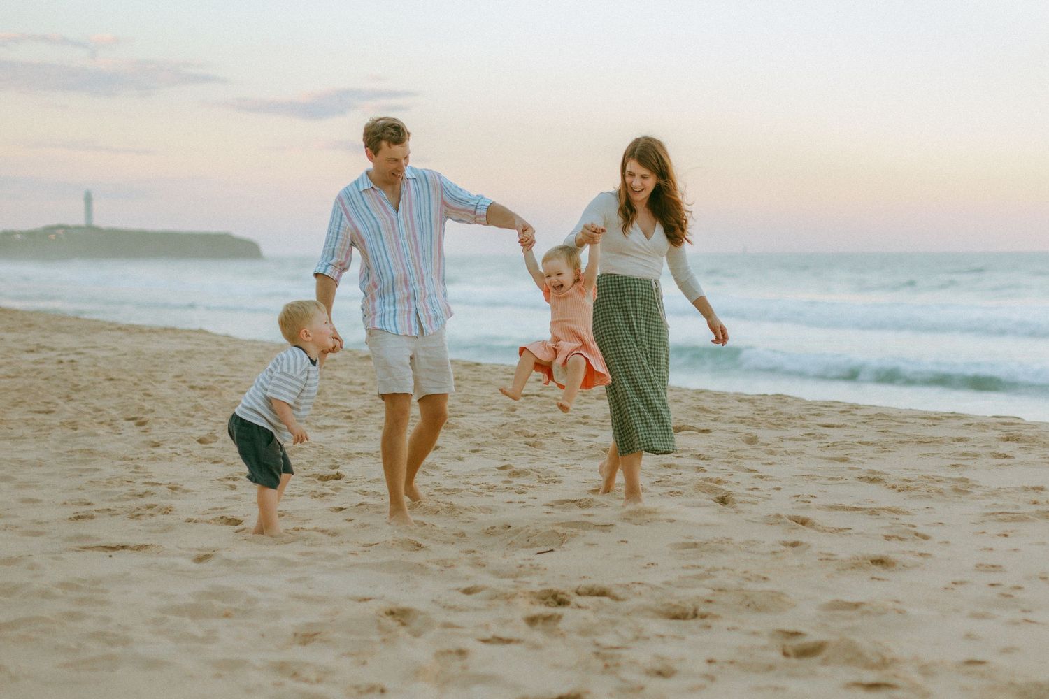 Family playing on Wollongong beach at sunset