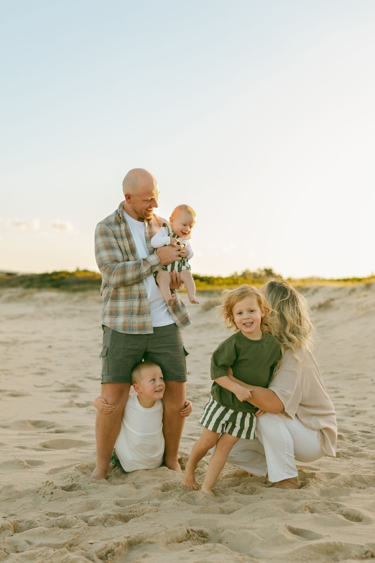 Family playing on beach in Wollongong NSW during golden hour.