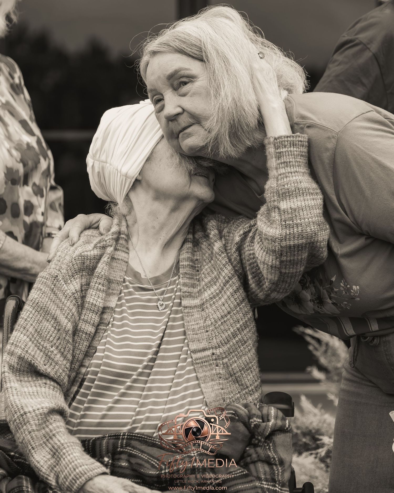 Black and white family portrait of an older woman being lovingly hugged by a family member in Little Rock.