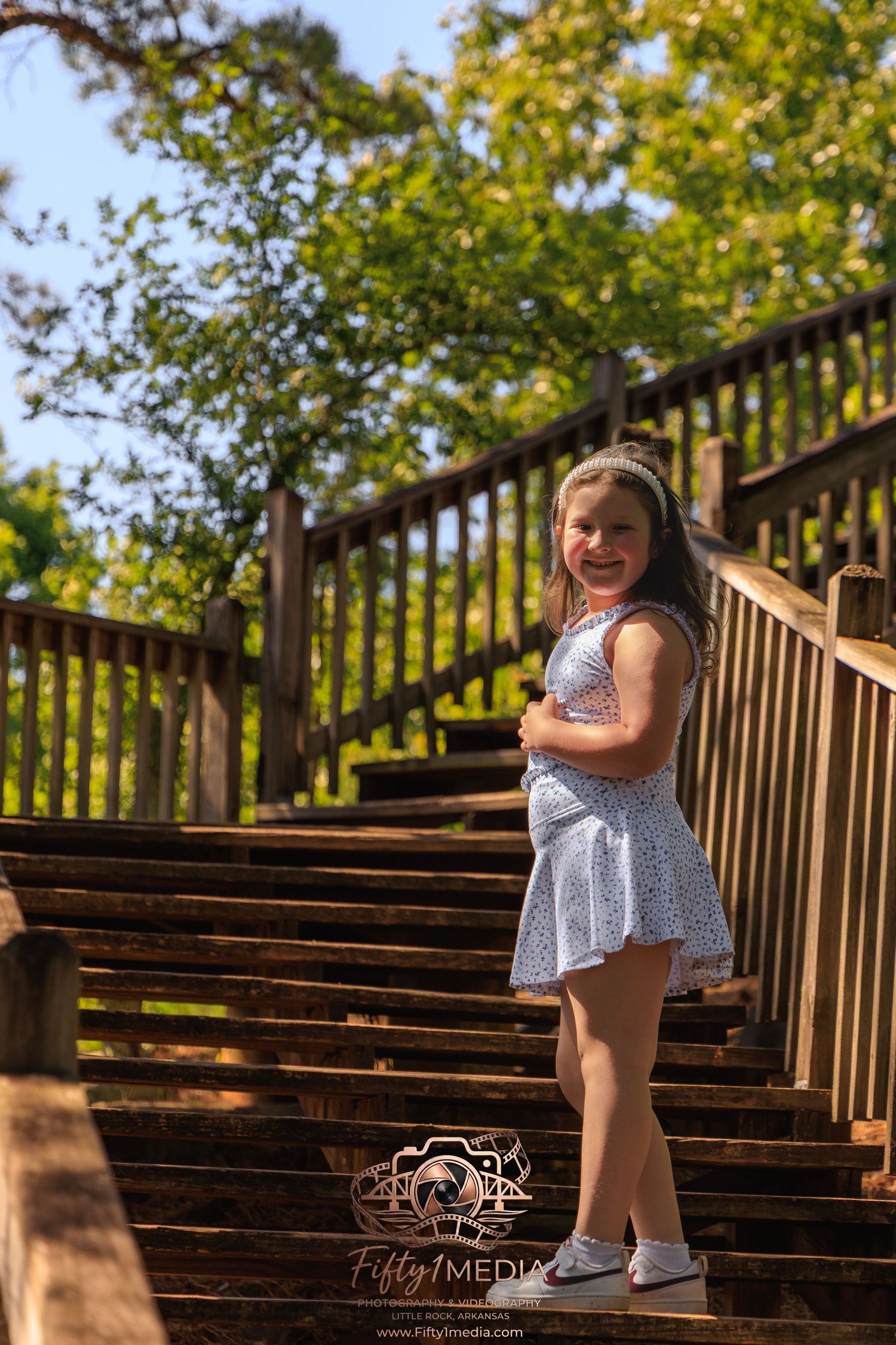 Young girl walking down wooden outdoor stairs in the woods, Little Rock portrait