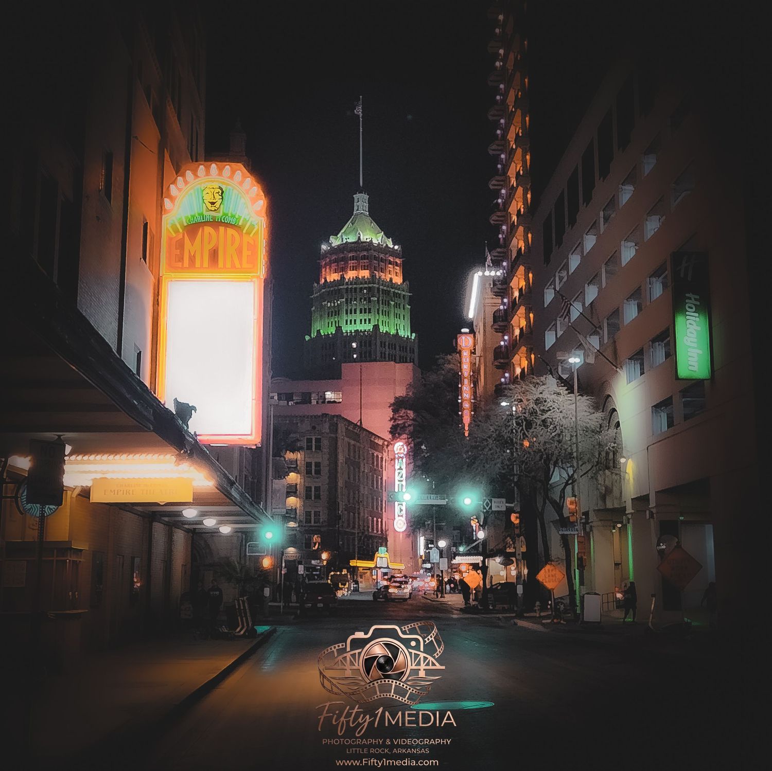 Nighttime street photography featuring neon signs and illuminated city lights in downtown Little Rock, Arkansas.