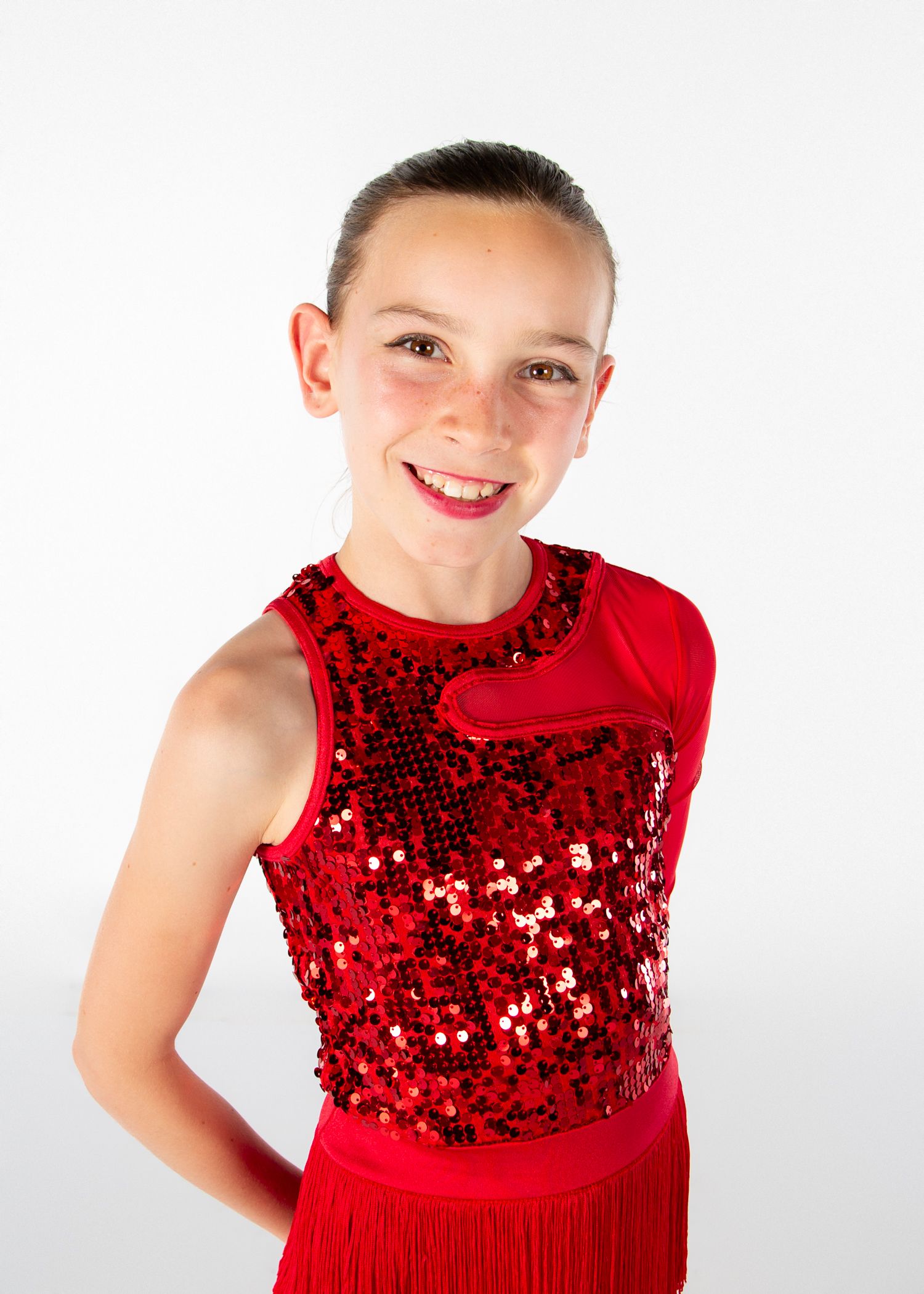 Performer wearing a sparkly red sequined dance costume with sleeveless design poses against white background.