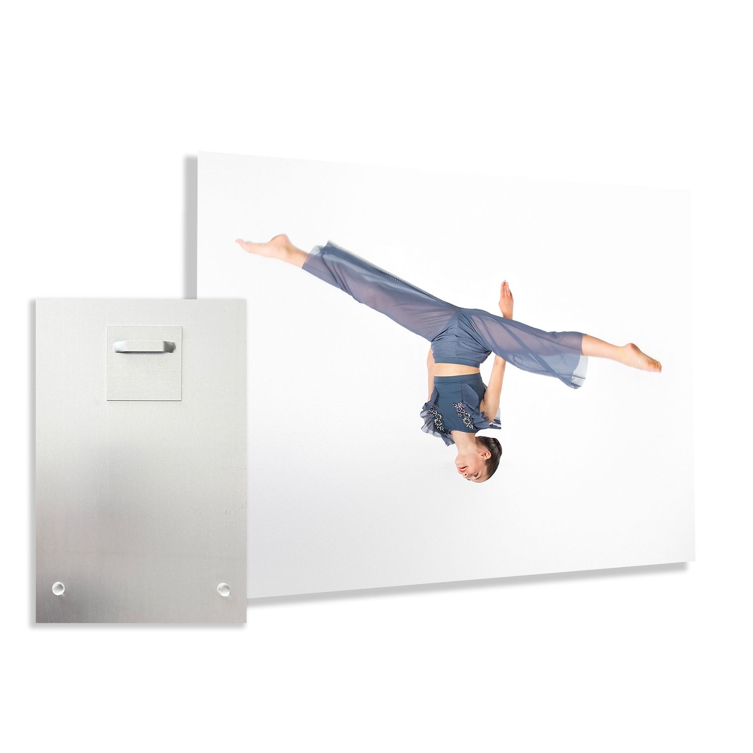 A gymnast performs a handstand split against a white wall next to a metal panel.