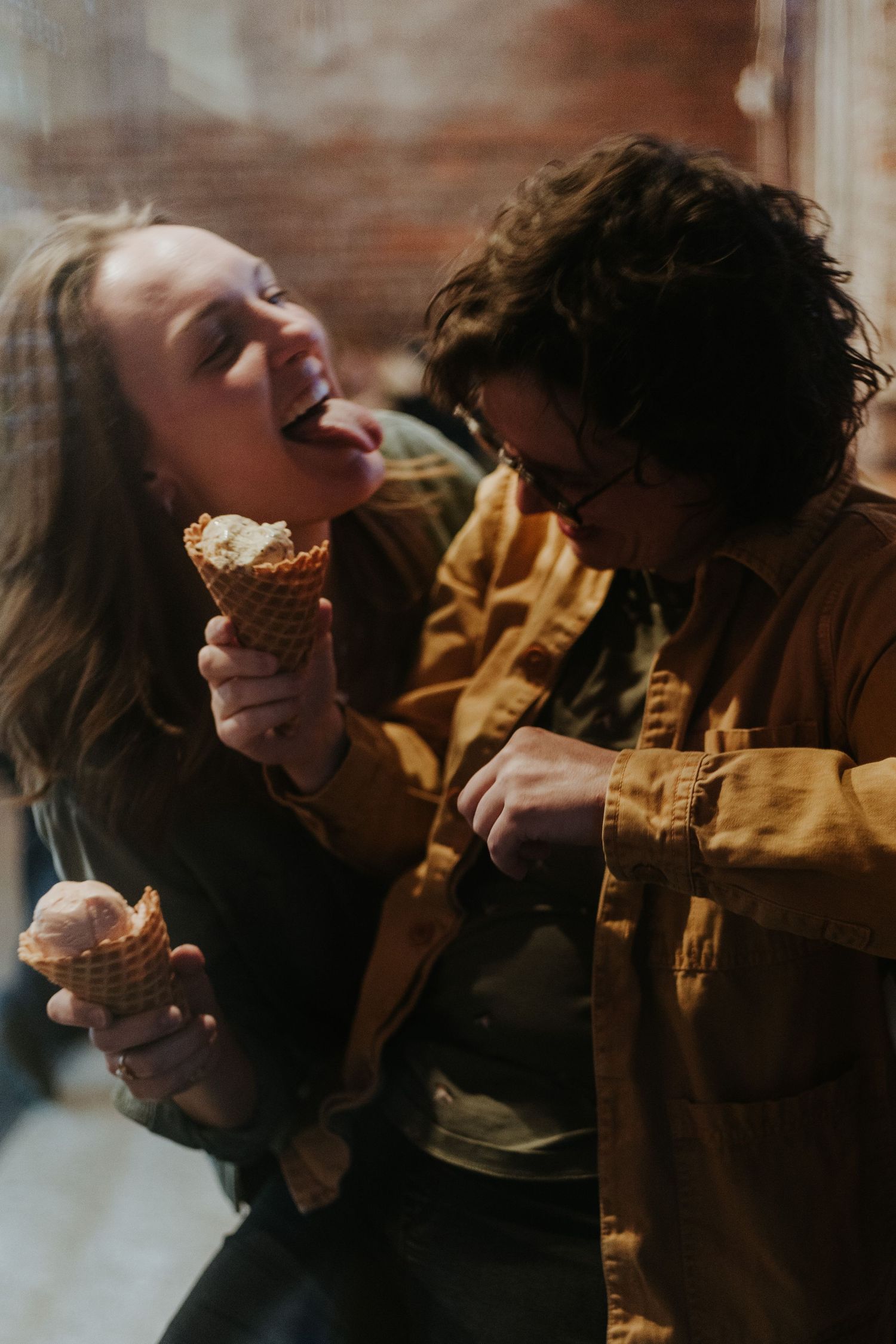 A series of candid photos showing two people laughing and enjoying cupcakes together in warm lighting.