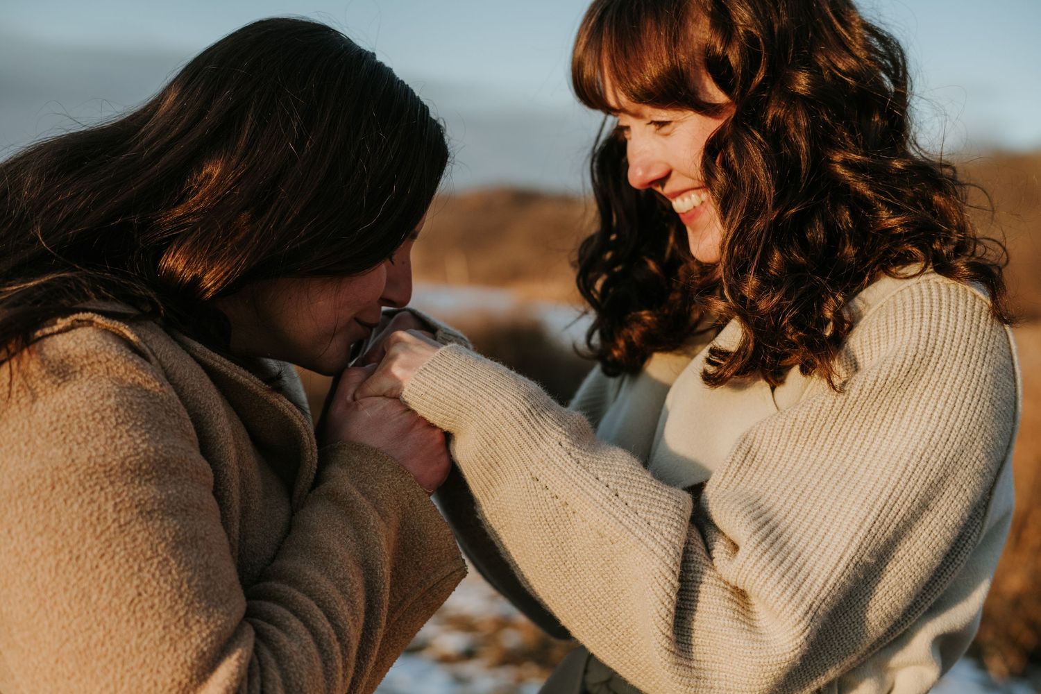 Couple sharing intimate moments together in a series of romantic outdoor portraits at sunset.