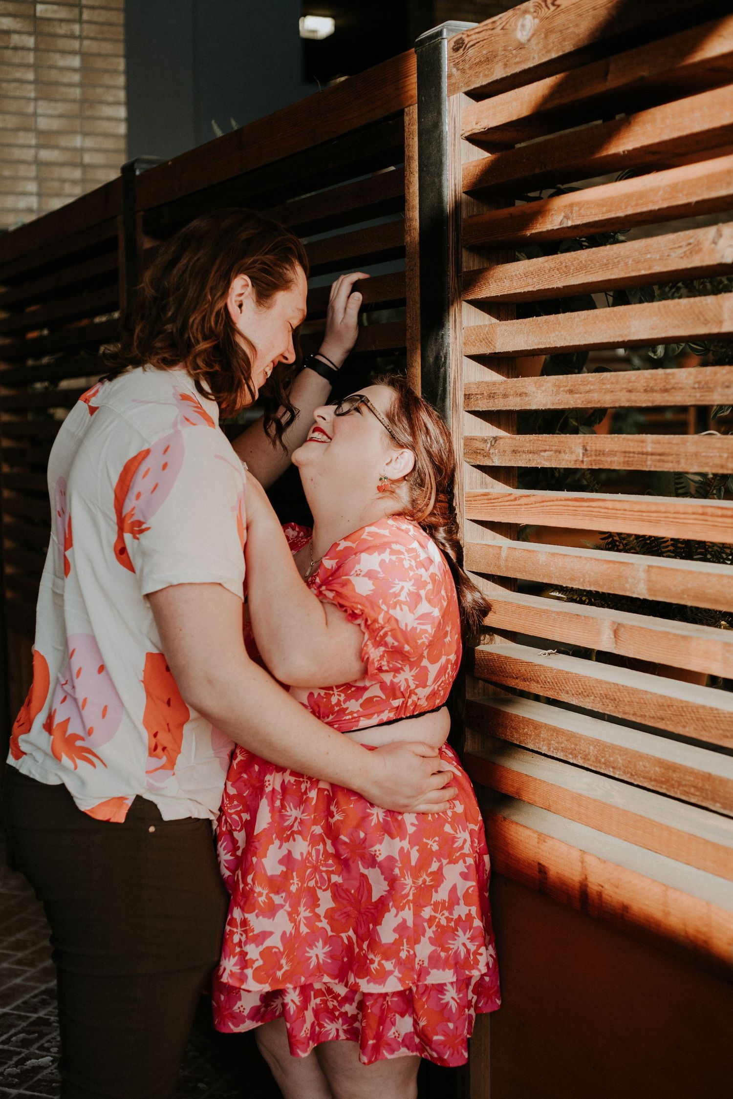 A series of intimate moments captured against wooden slat walls in dim lighting.