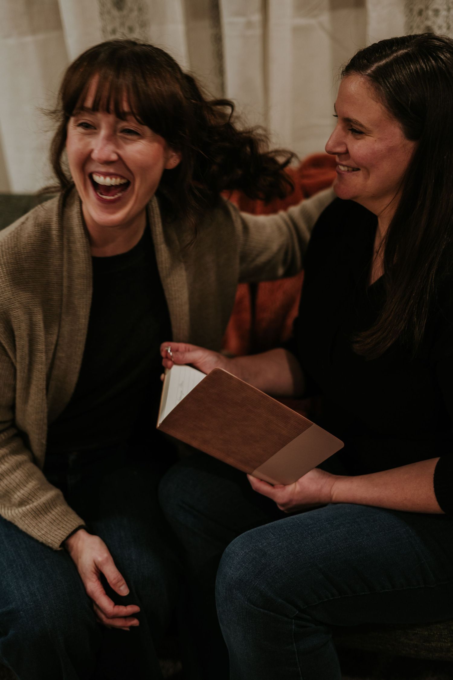 A candid photo series showing laughter and conversation between friends sitting together on a couch.