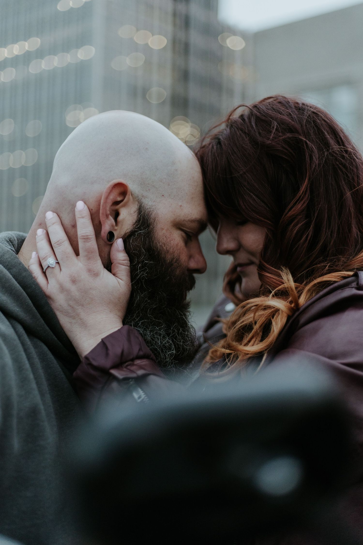 Two people sharing an intimate moment together in a moody, atmospheric setting.