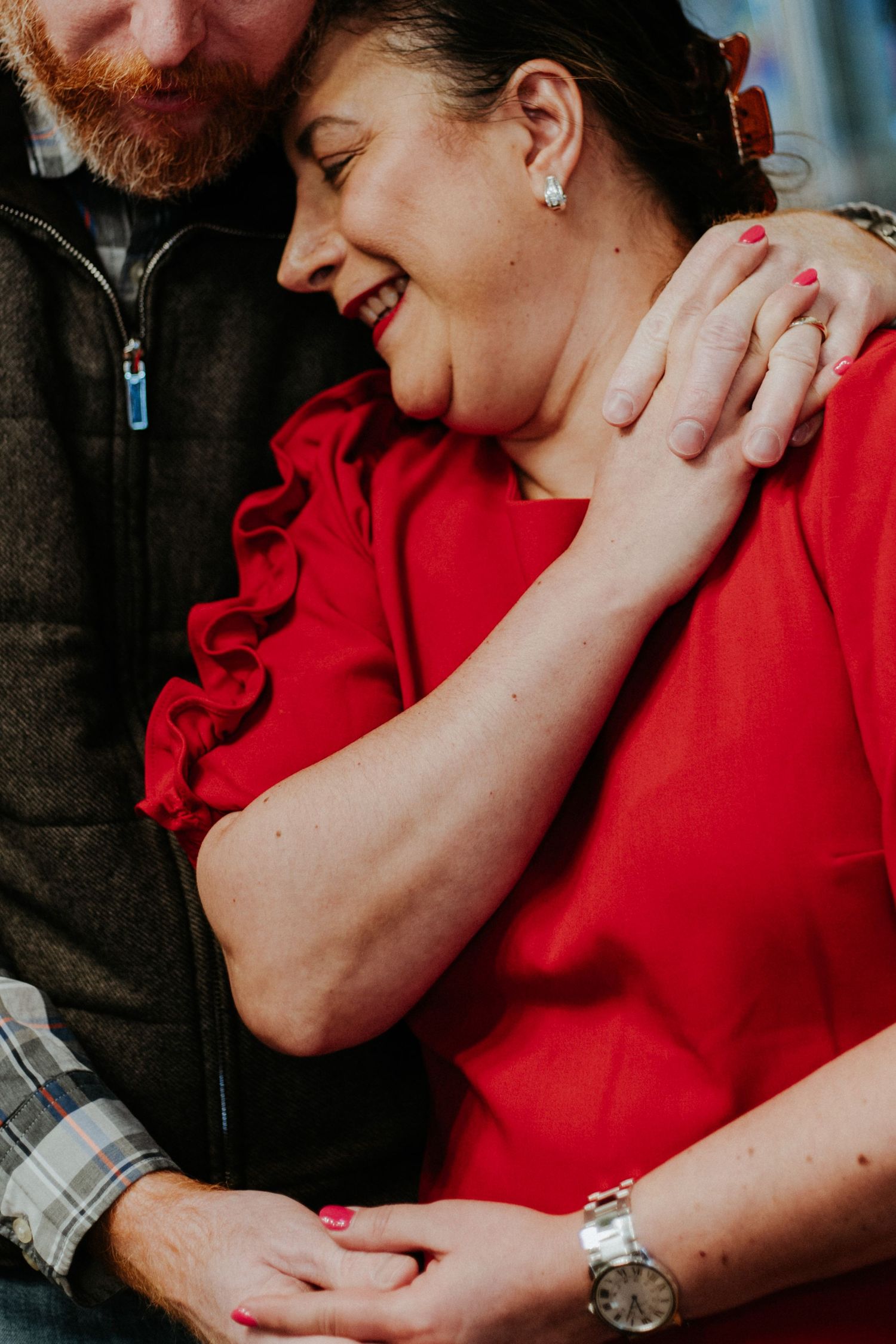 Intimate couple in red and dark clothing share tender romantic moments in a series of close-up photographs.