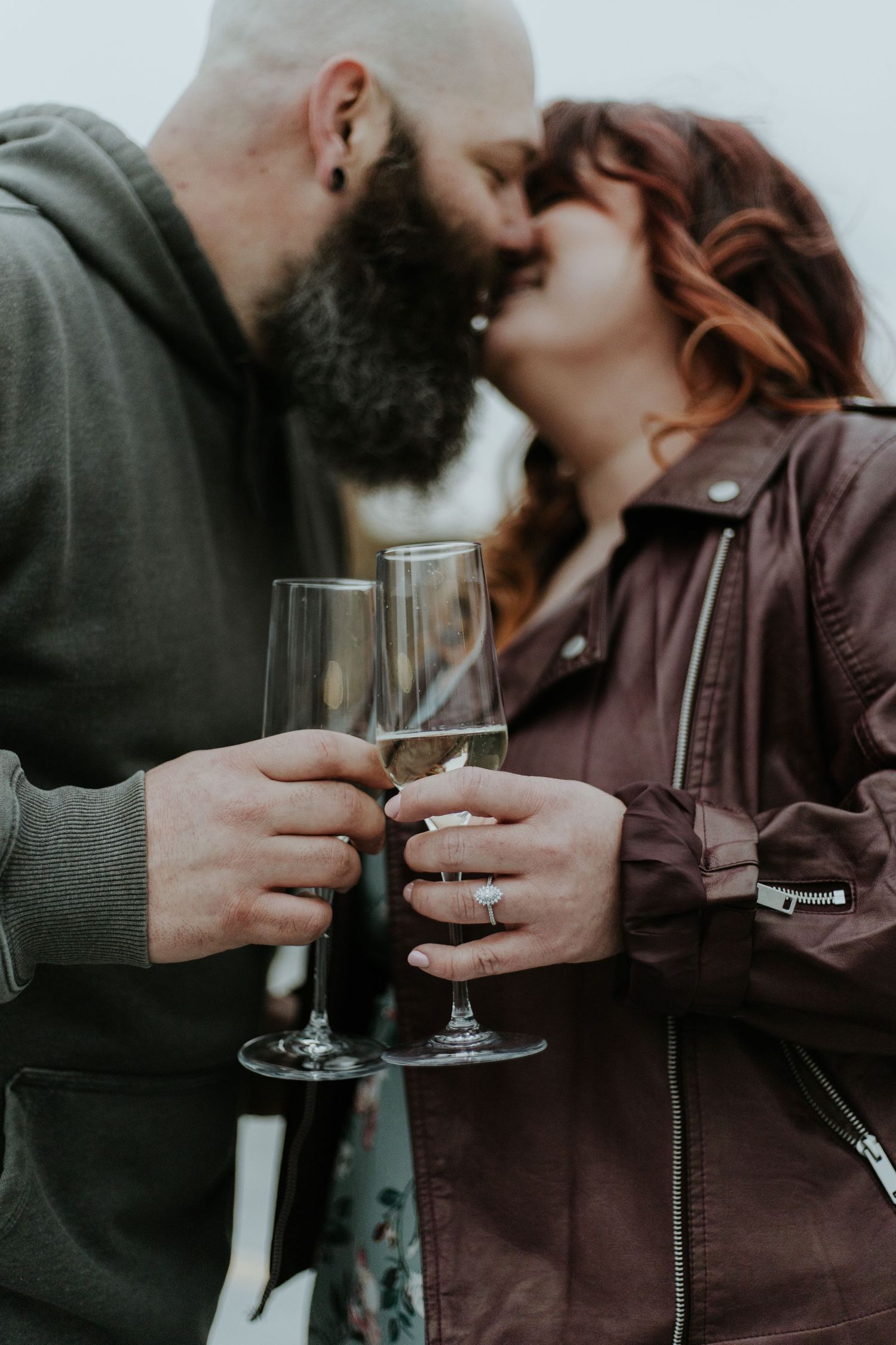A romantic couple shares intimate moments while holding wine glasses in a series of moody black and white photographs.