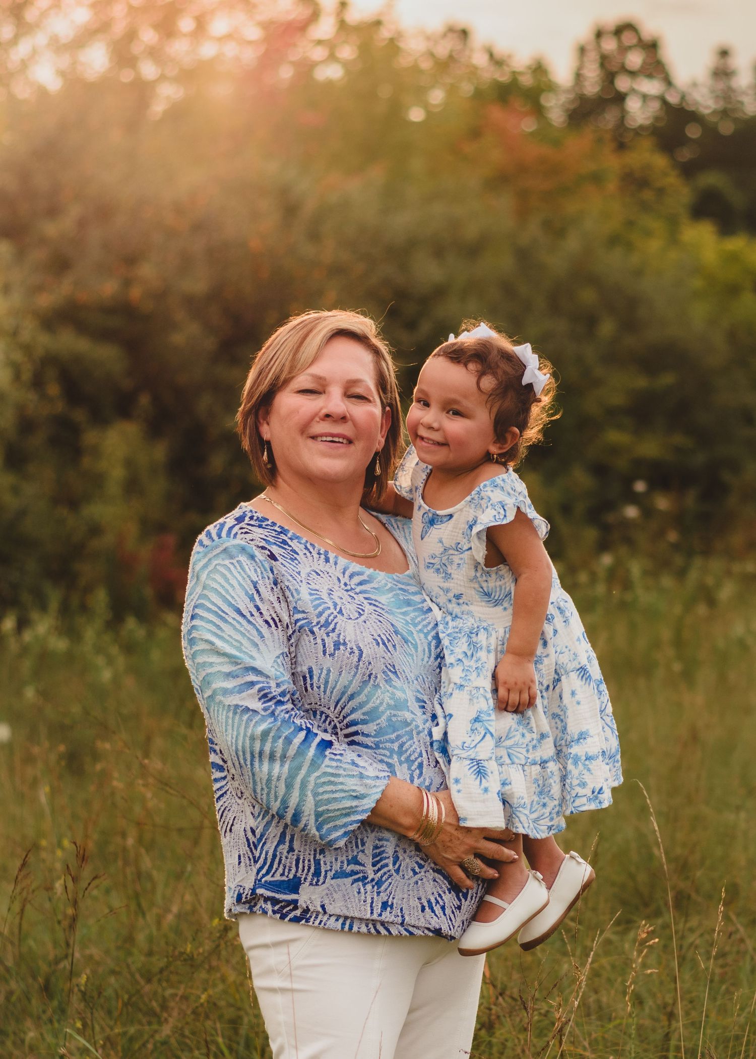 A heartwarming outdoor portrait showing a special moment between two people in matching blue outfits.