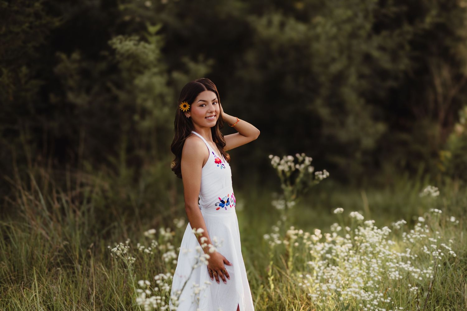 Senior floral dress standing in a wildflower field, smiling over her shoulder Lafayette, Indiana
