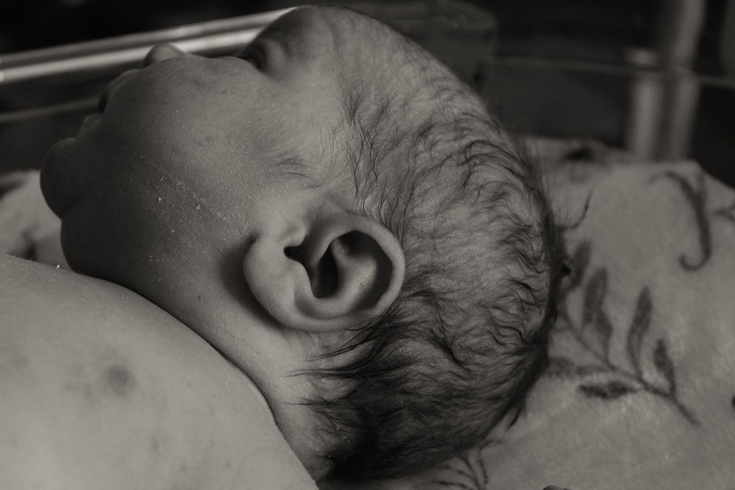 Black and white close-up detail of an infant's features.