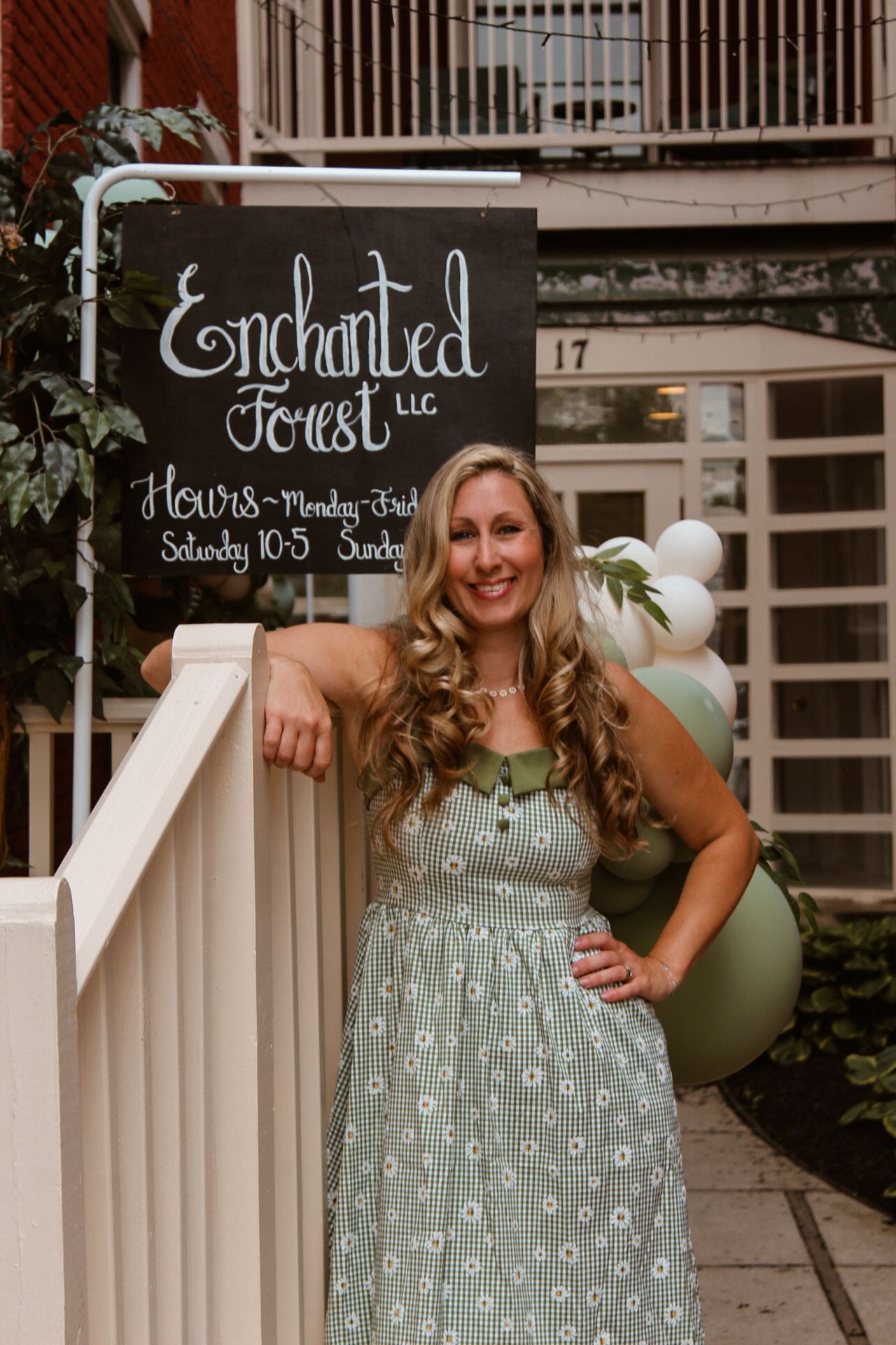 Outdoor scene with cute mushroom decorations and balloons against a white porch railing.