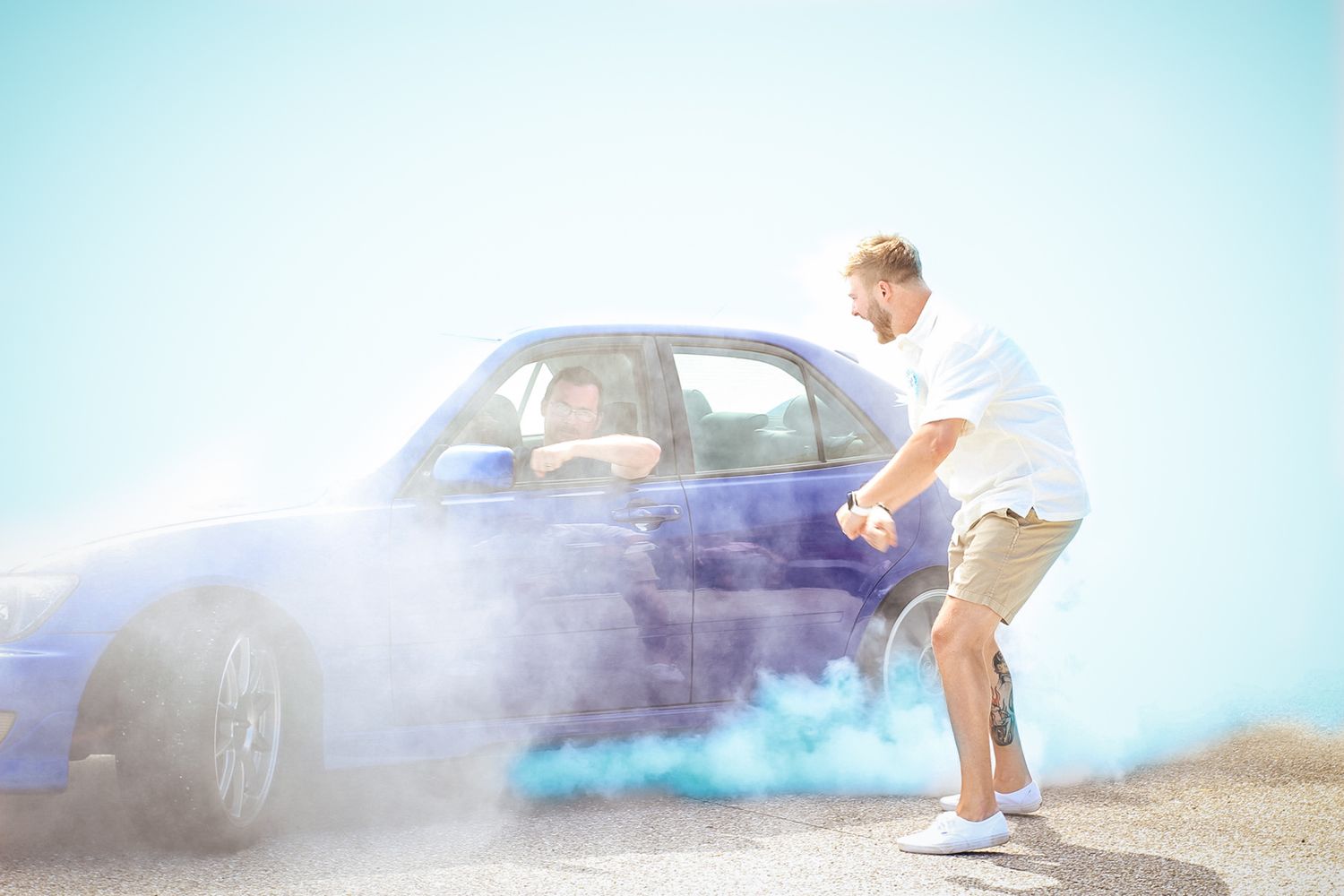 Blue smoke effect photoshoot in an outdoor setting with dramatic lighting.