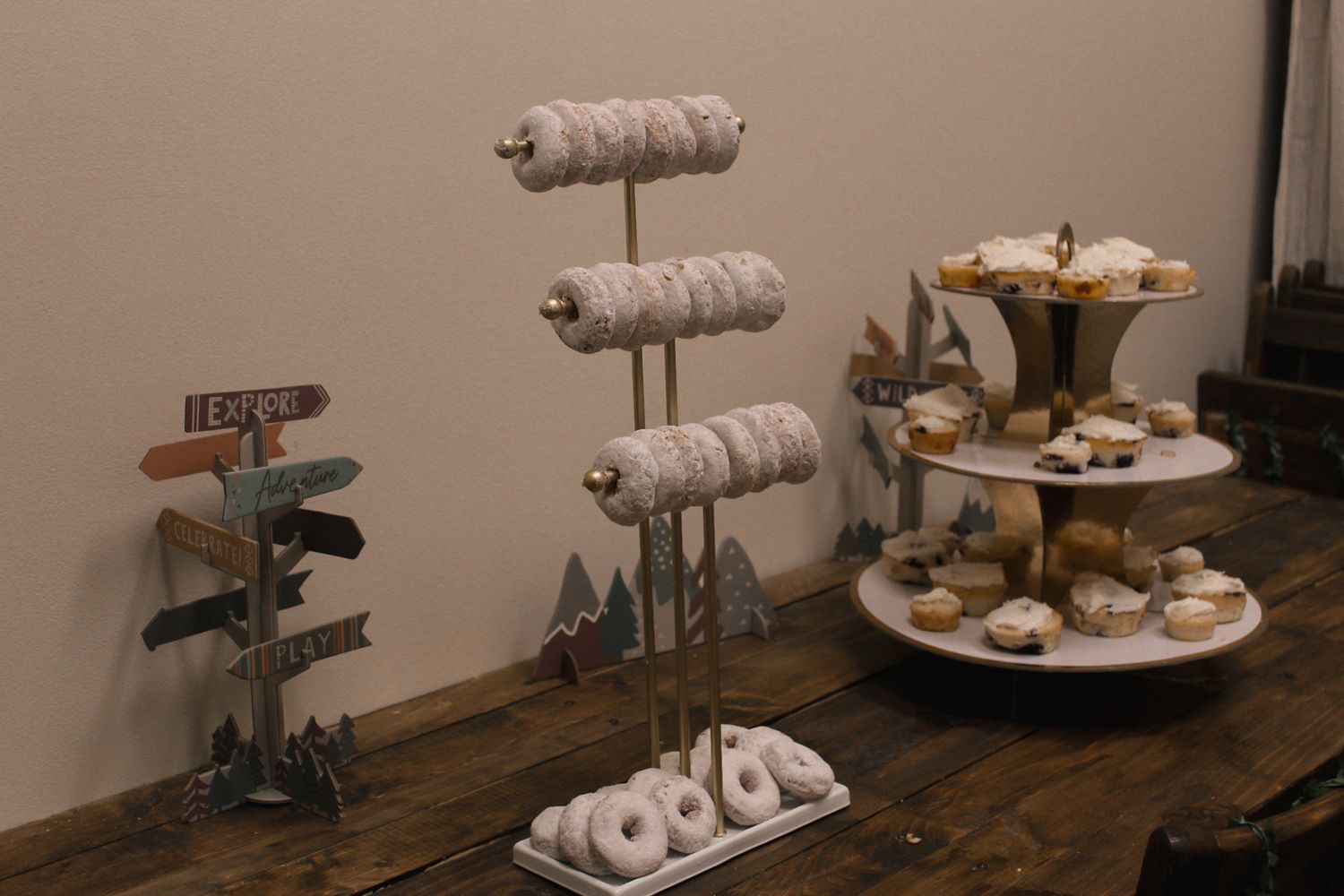 Close-up view of decorated pastries and snacks arranged on tiered wooden stands.