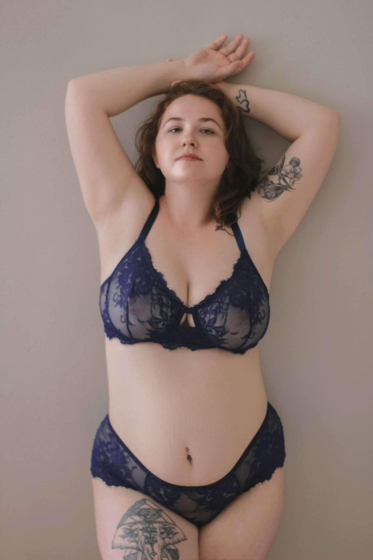 Portrait in navy blue lace lingerie set showing delicate details and natural curves.
