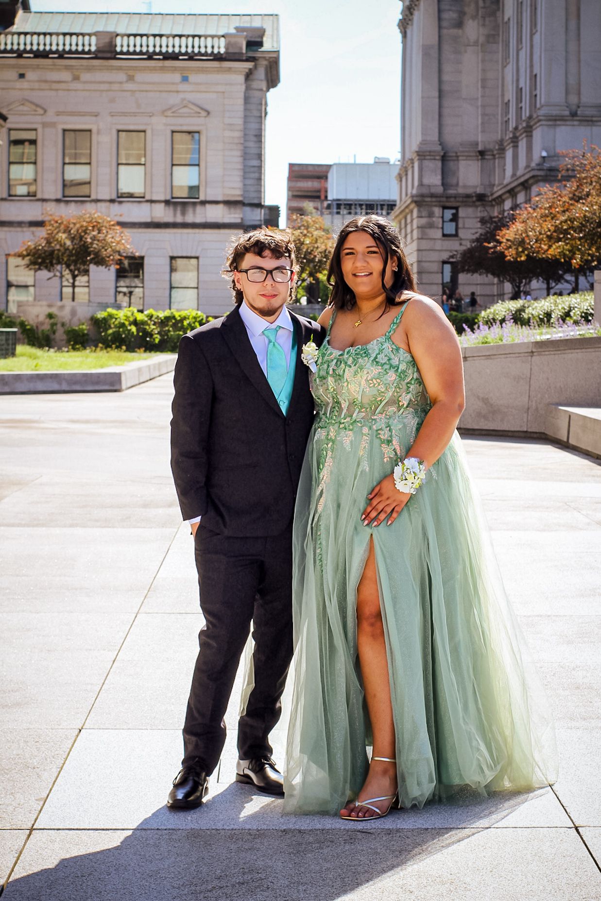 A formal portrait session outside a government building features a mint green gown.