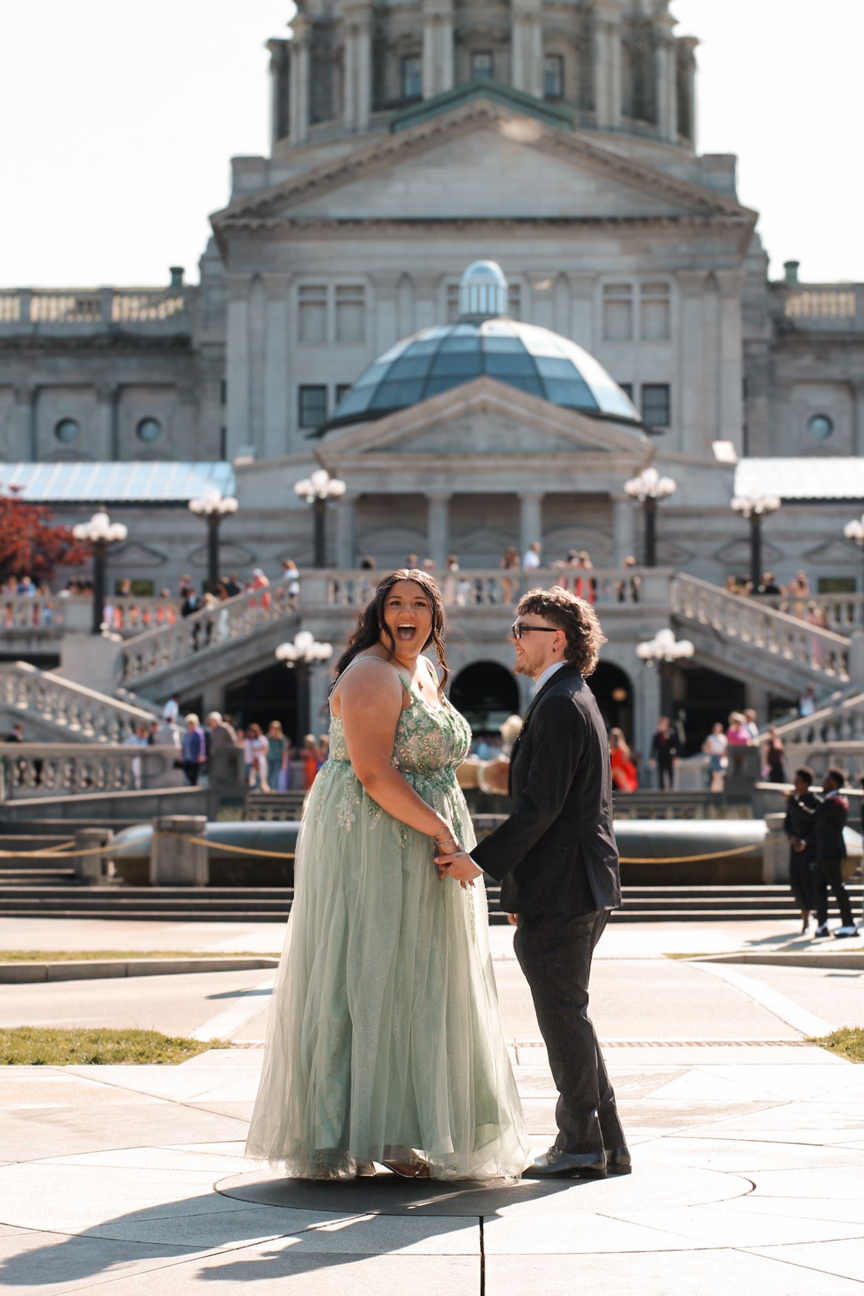 A romantic photoshoot moment on the steps of a majestic capitol building.