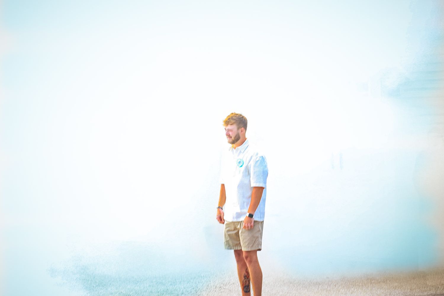 Bright outdoor scene with ethereal blue smoke effects against a light background.