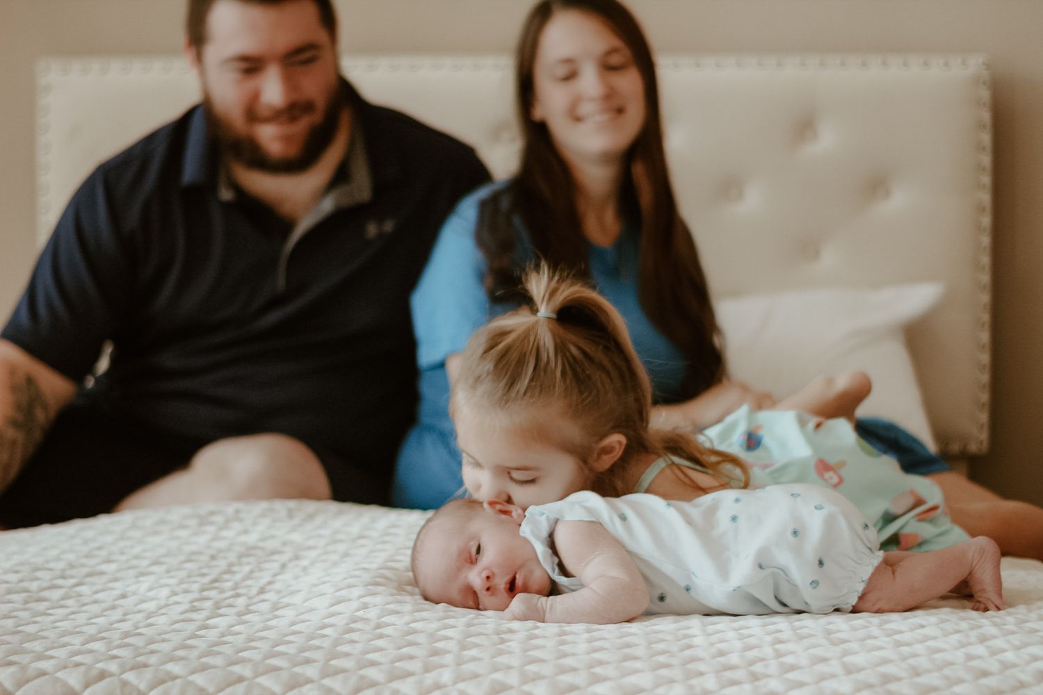 A collection of tender family moments showing parents with a newborn baby in a series of black and white photographs.