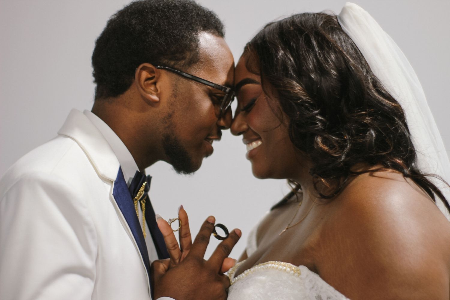 Close-up wedding portrait showing a tender moment between newlyweds.