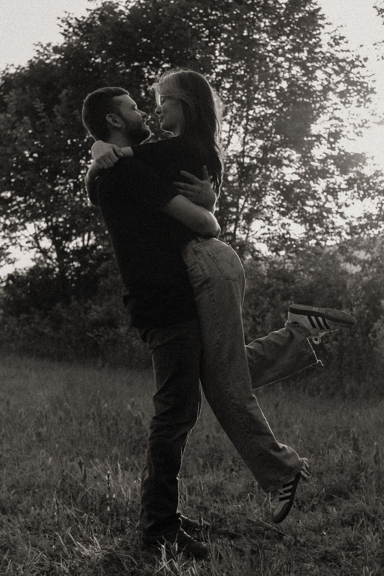 Romantic black and white photo sequence of couple dancing in a field.
