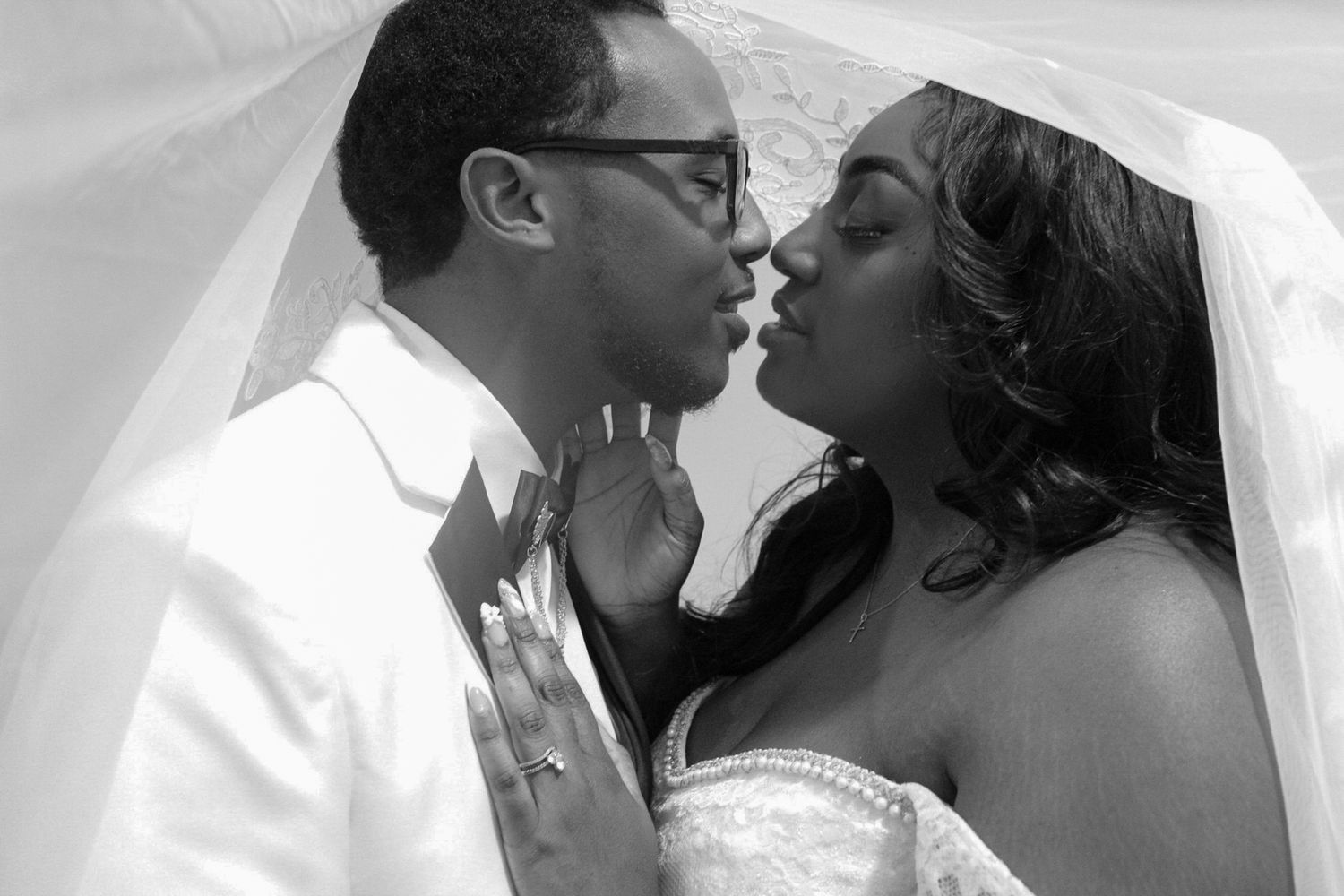 Black and white romantic wedding portrait under flowing veil.