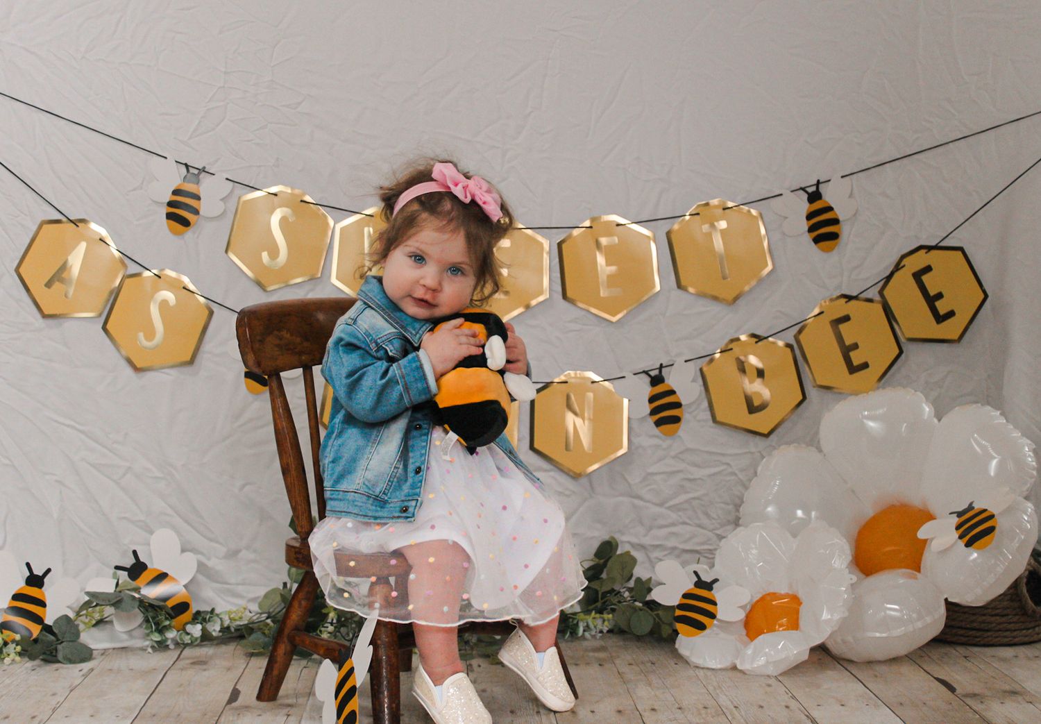 Honeycomb-shaped banner decorations with bee motifs strung across the wall.