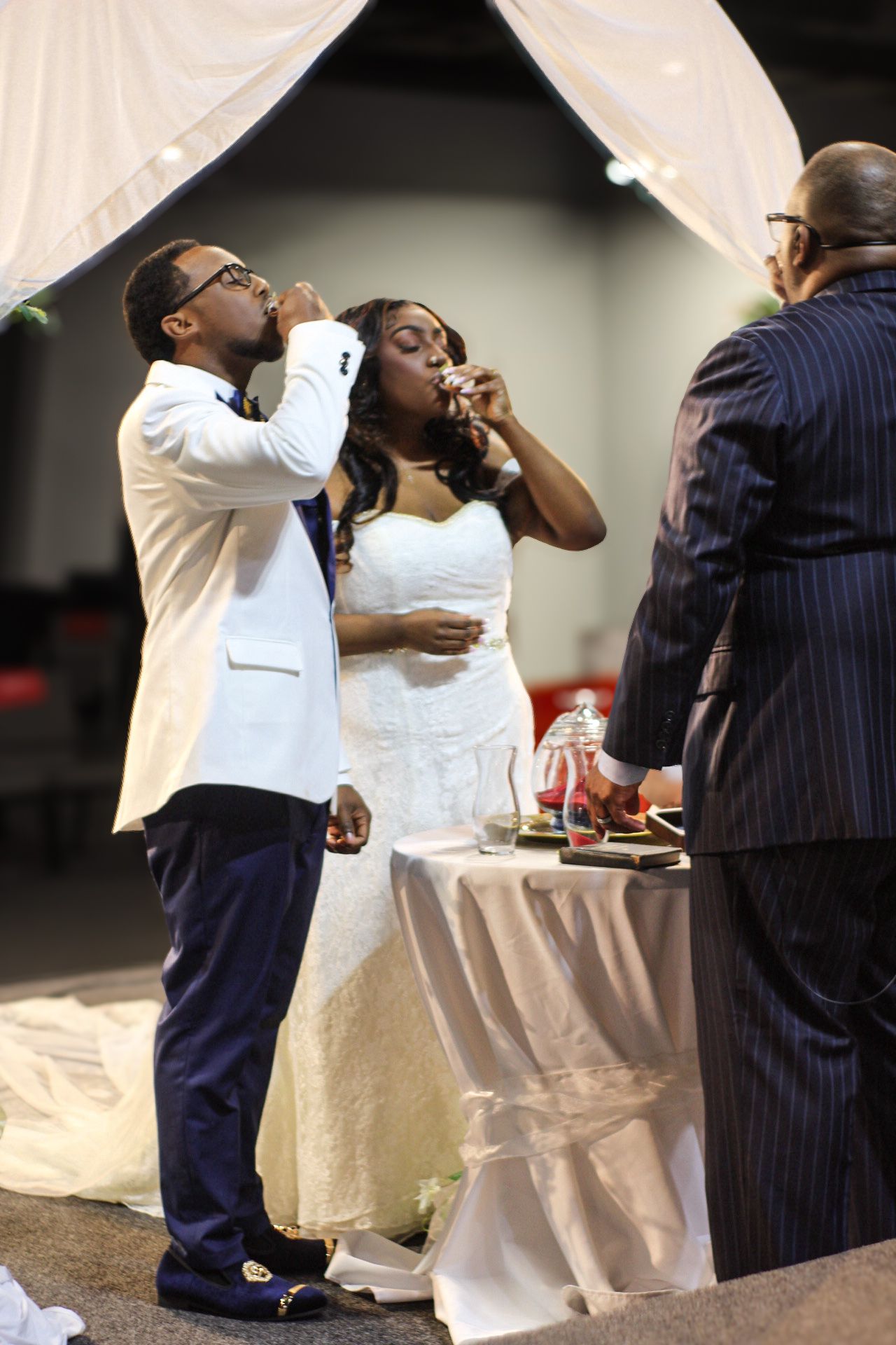 Wedding reception guests enjoying refreshments at an elegantly decorated table.