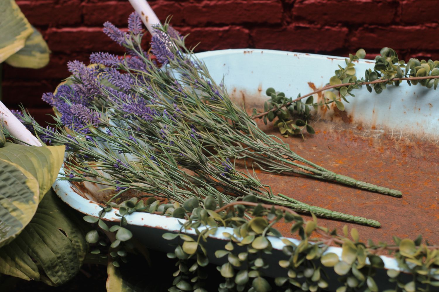 Dried lavender and wildflowers arranged on a rustic brick surface.