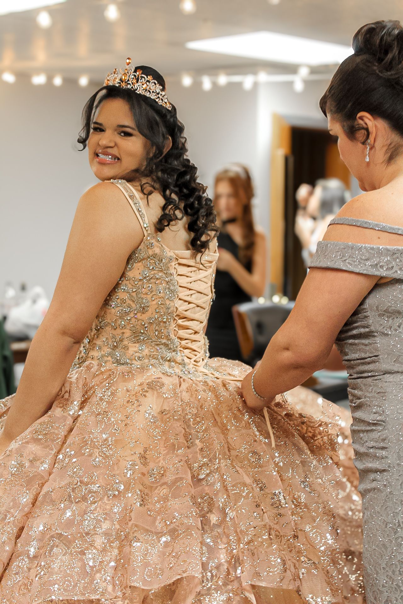 A celebration featuring a sparkly rose gold ball gown with intricate lace details.