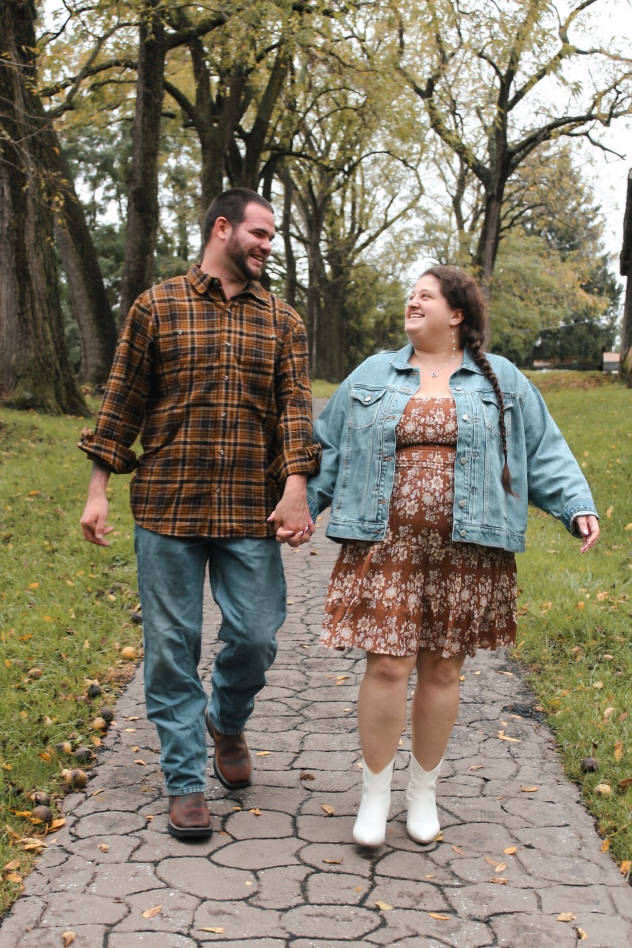 Walking together on a paved garden path in casual autumn attire.