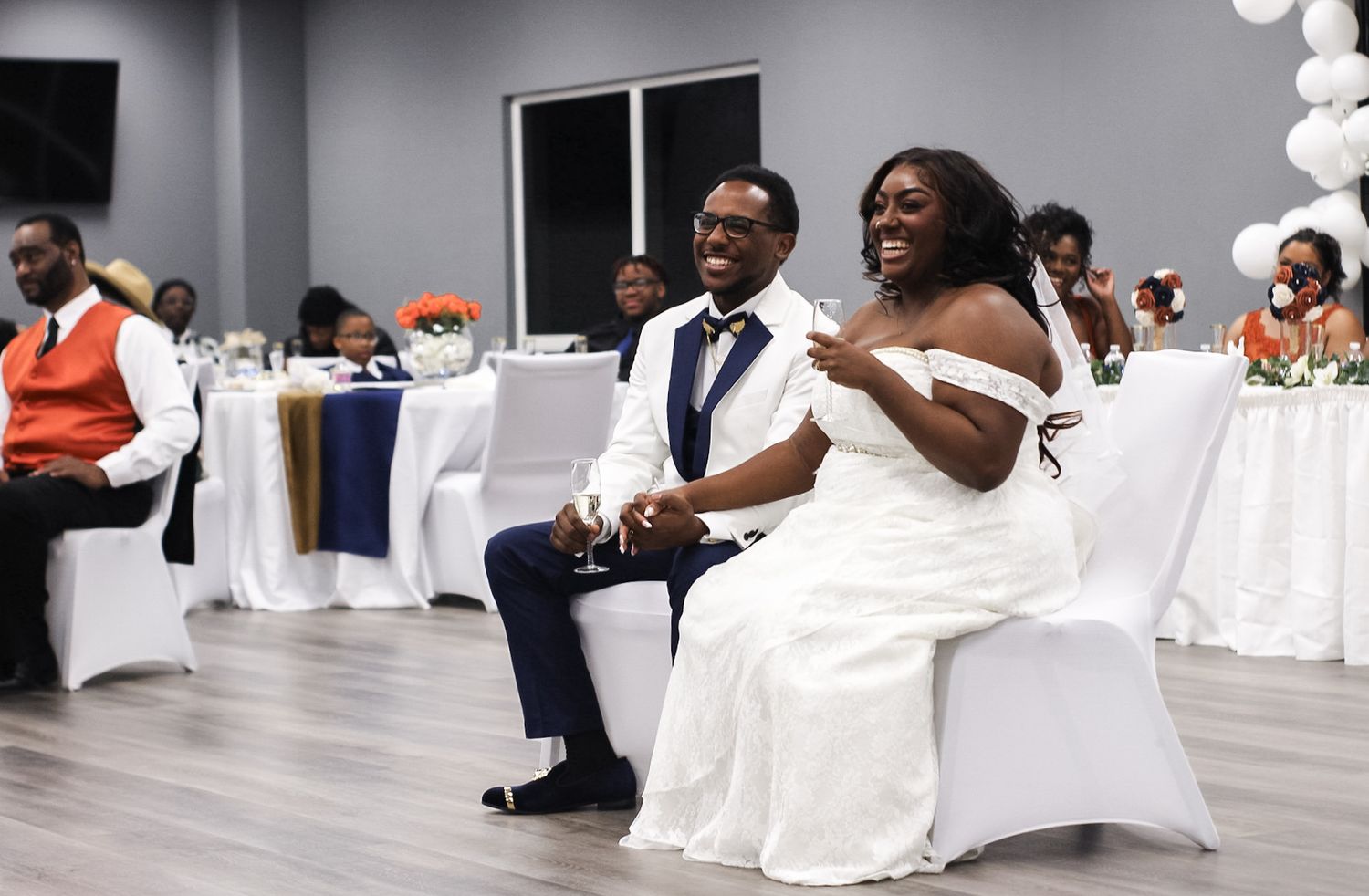 Wedding reception moment showing couple enjoying celebrations in elegant venue.