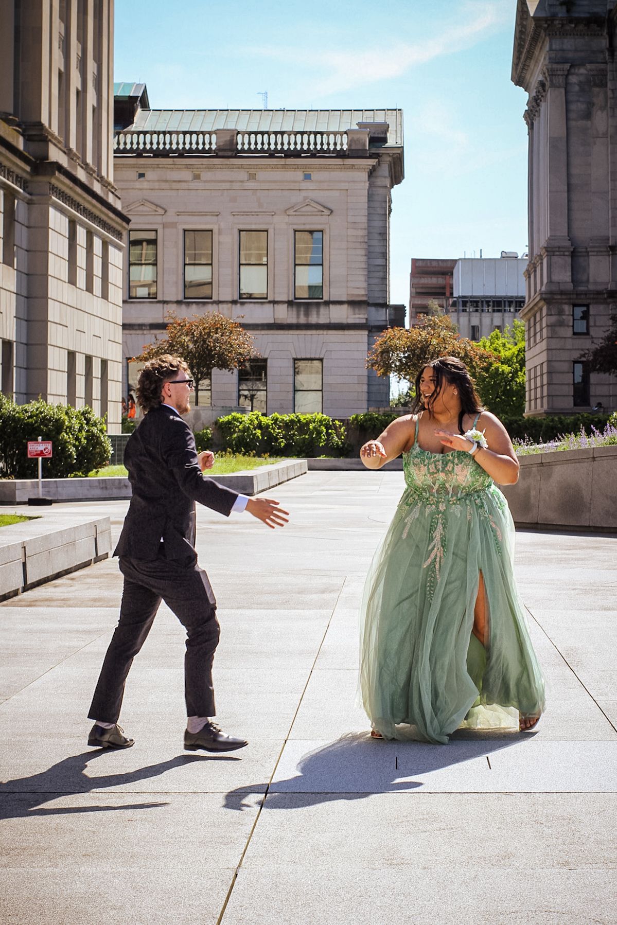 Candid dance moves captured in a series on a stone plaza.