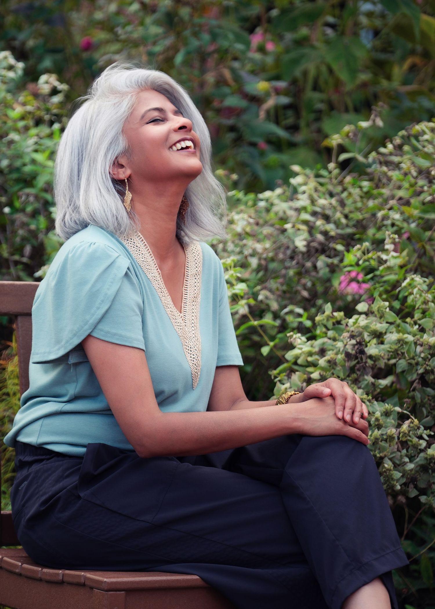 A joyful moment captured in a garden setting with soft natural lighting.