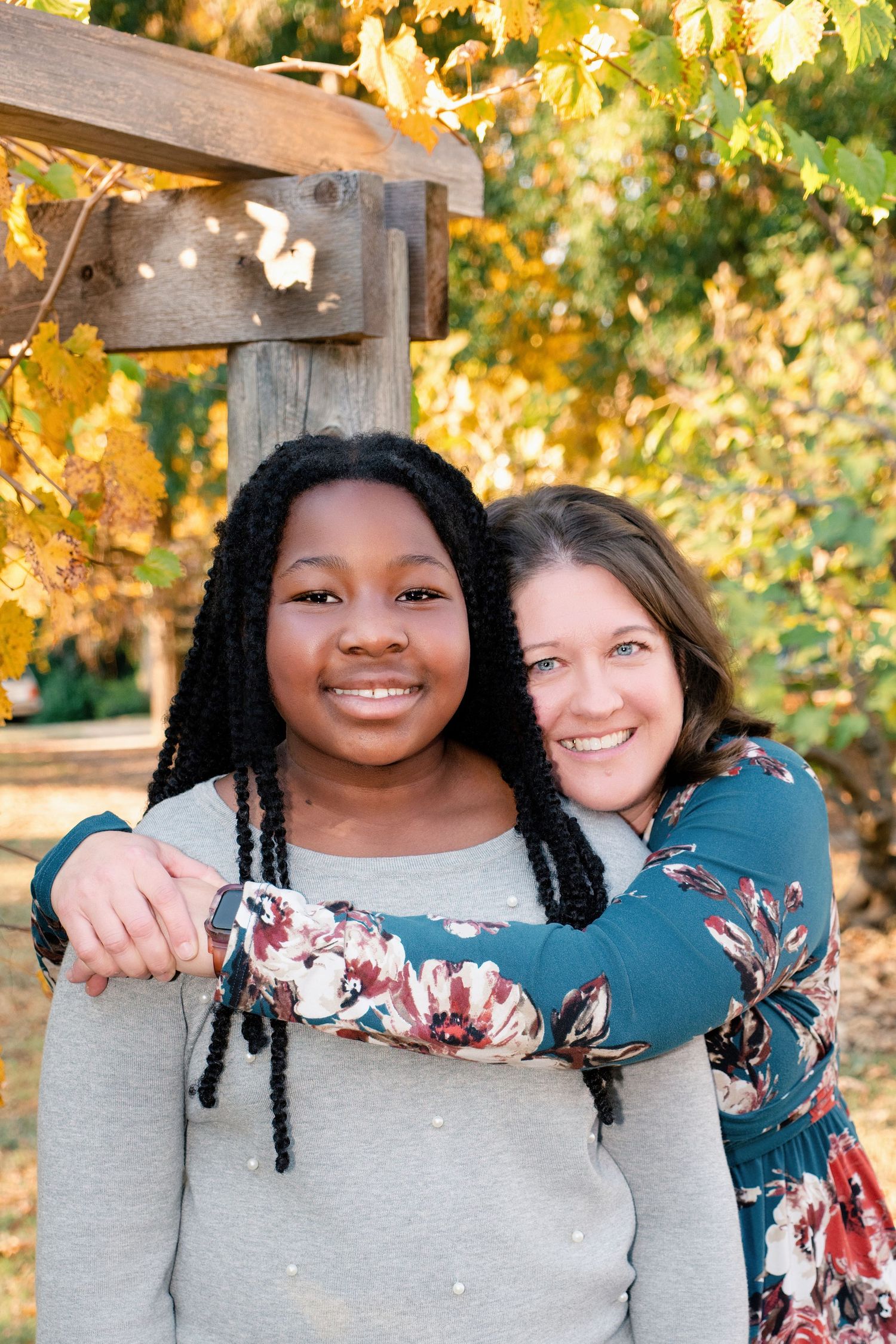 A series of candid photos showing two friends in matching floral and gray sweaters against an autumn backdrop.