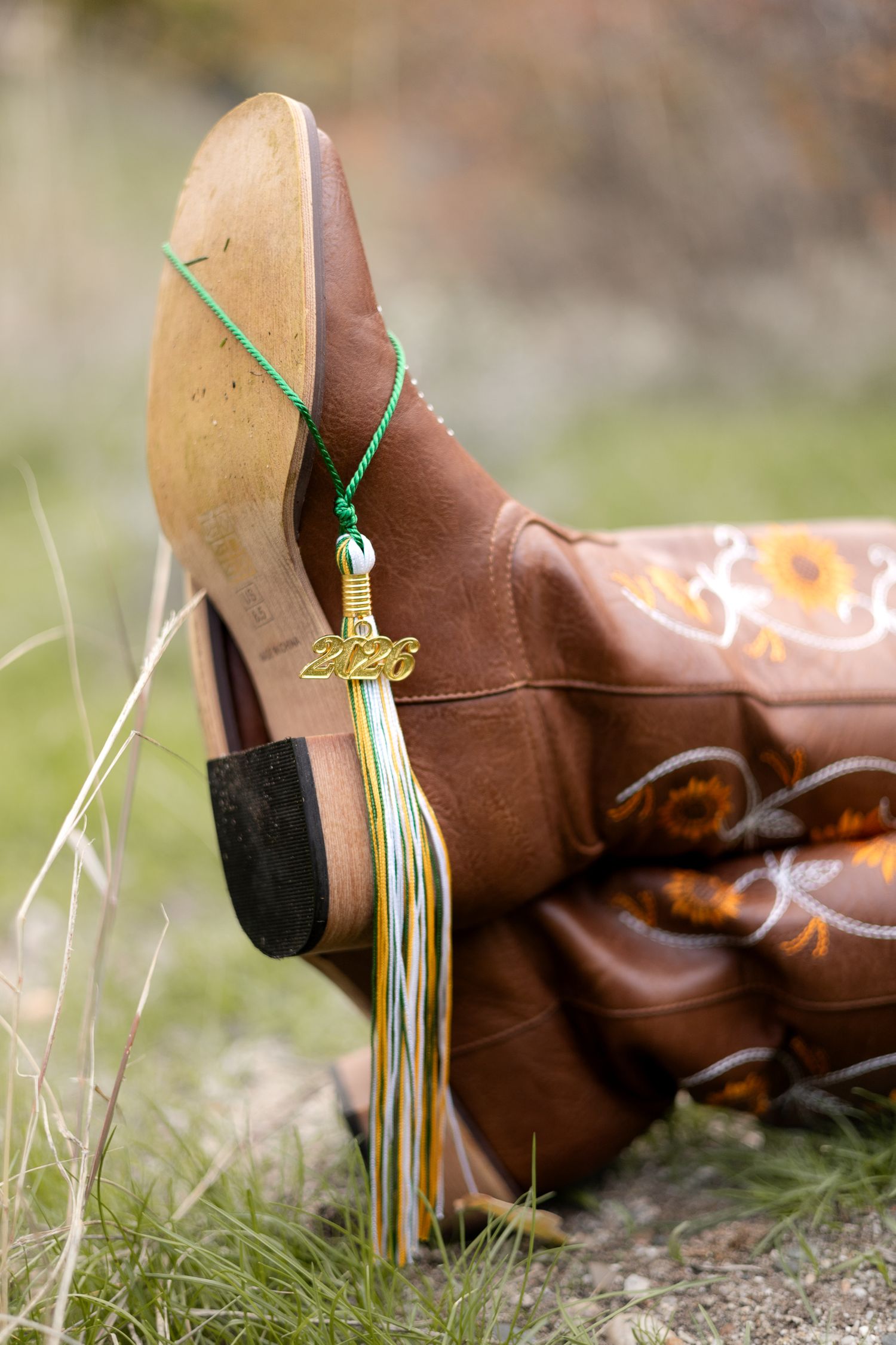 senior graduation photo cowboy boots and tassel