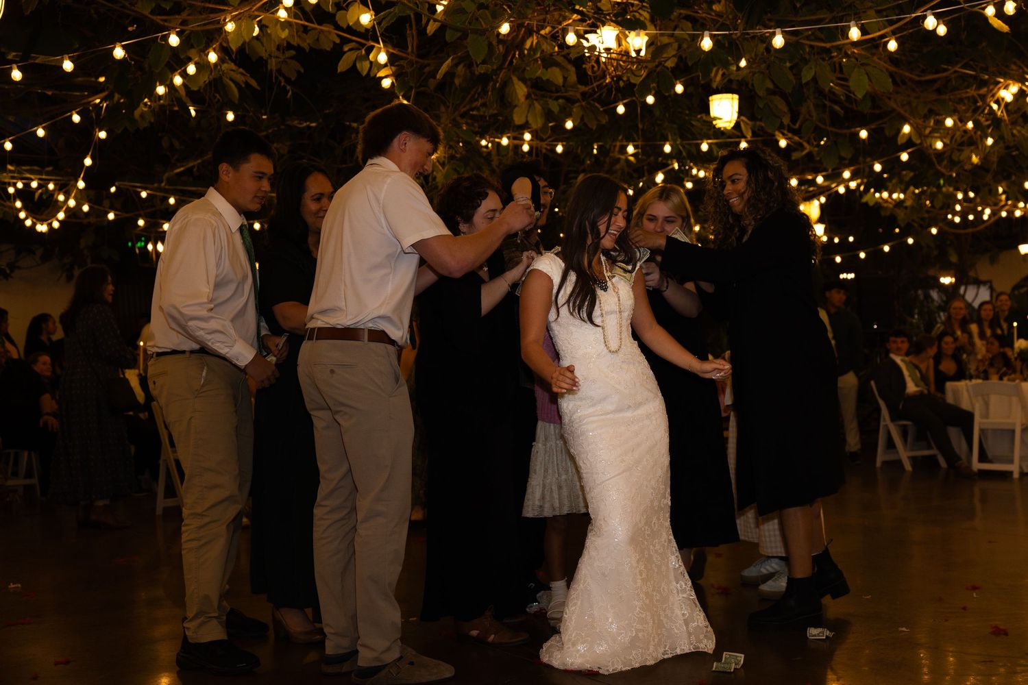 bride doing money dance during reception